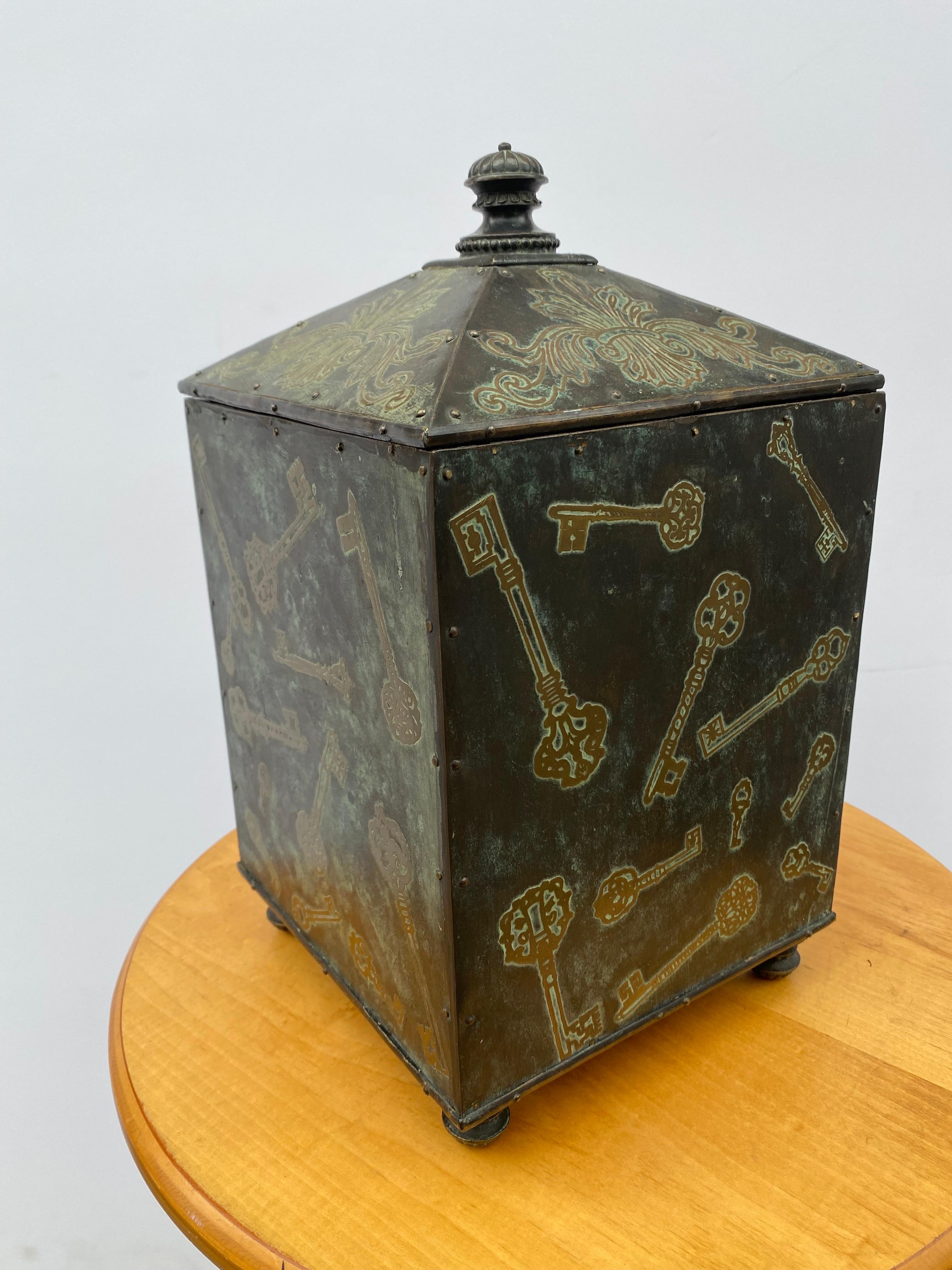 Maitland Smith lidded box. Key design on 4 sides with a peaked lid. Very nicely done. Whimsical 
Design that has a functional use!