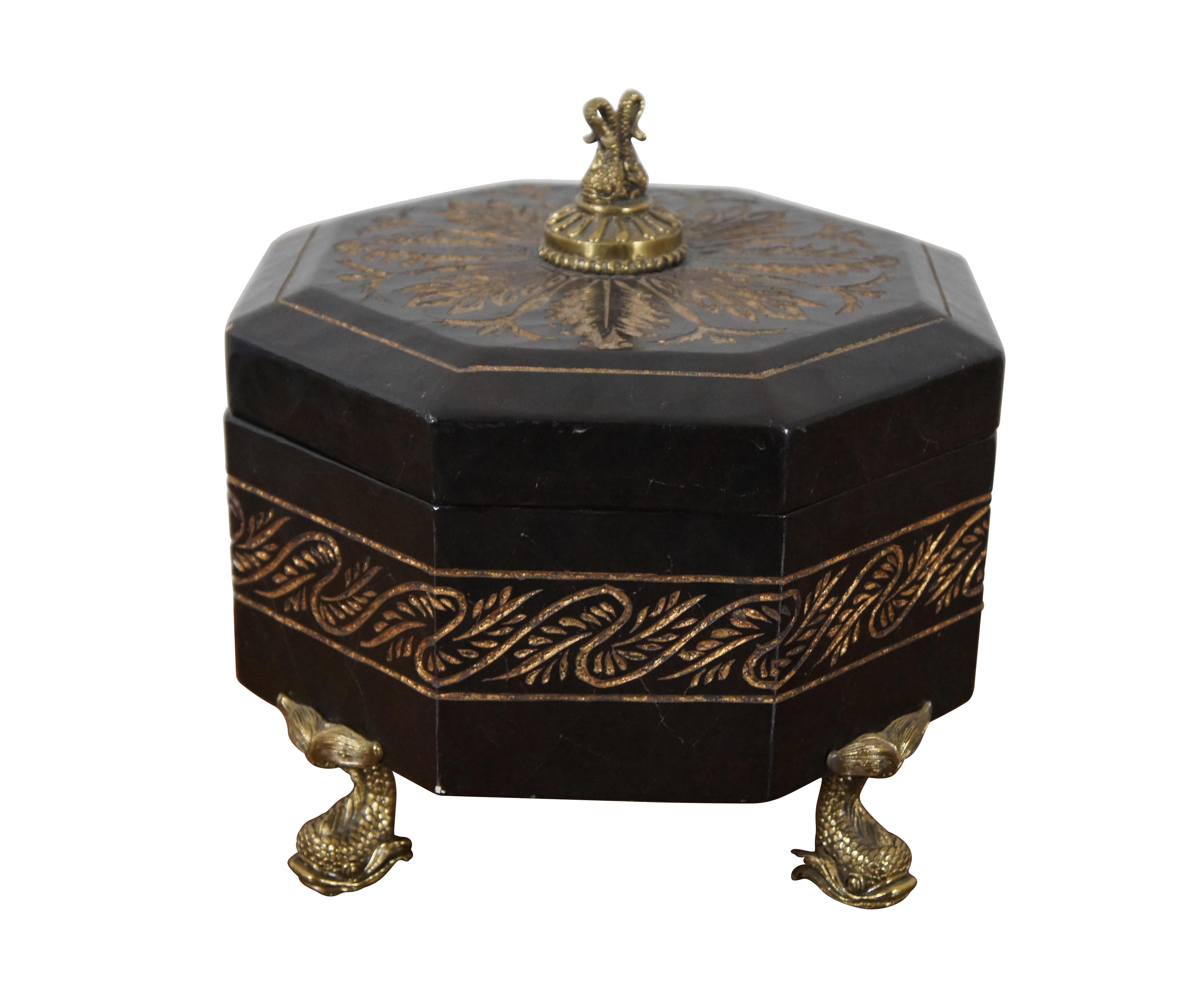 Vintage octagonal keepsake box, finished in black lacquer with engraved foliate designs painted with gold, supported by four gold / brass delphin / dolphin / fish shaped feet, and a matching double delphin finial on the lid.

Dimensions:
11.25” x