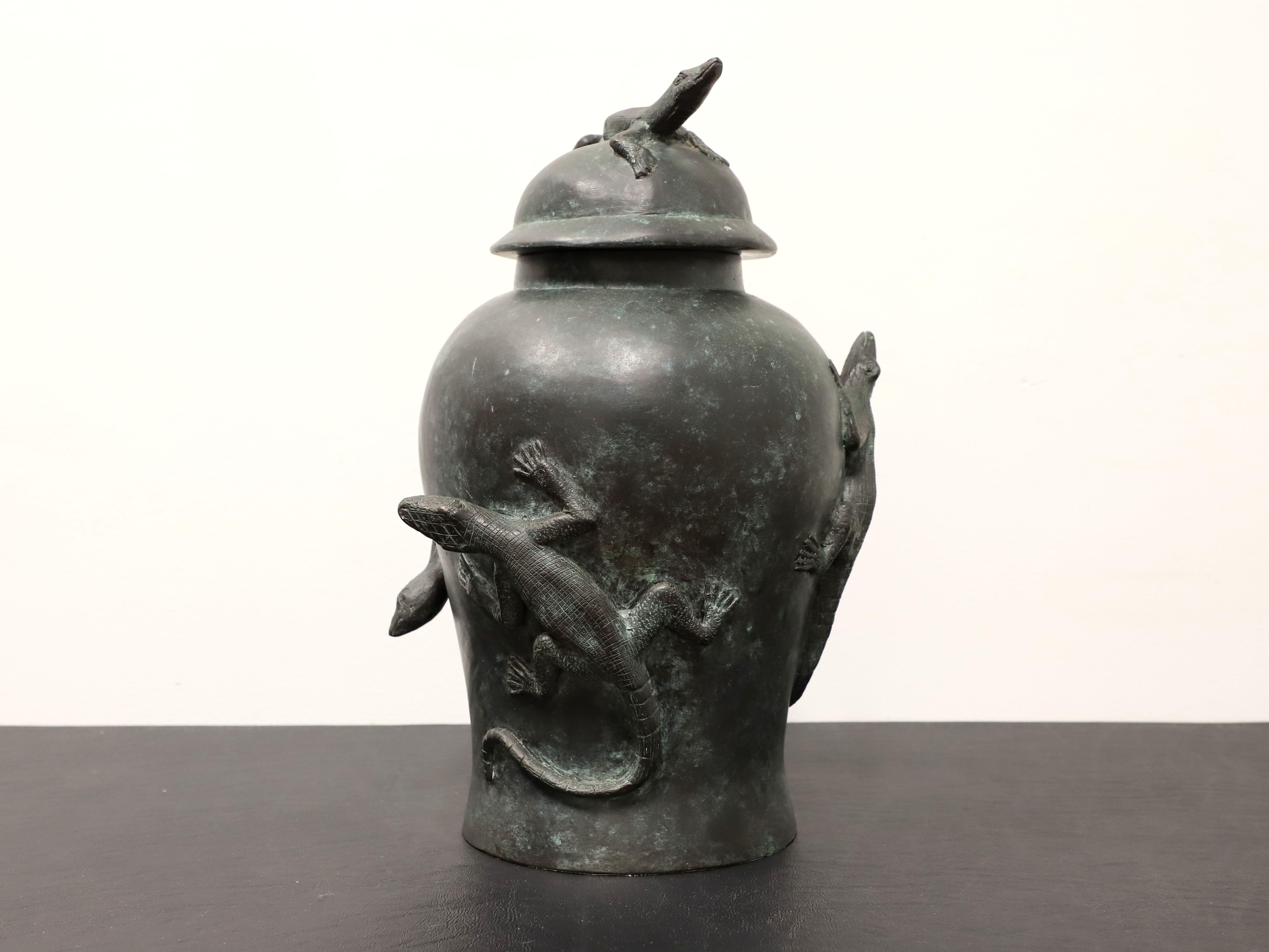 A table top urn in bronze with lid by Maitland Smith. Cast bronze with a patinated hue and lizards motif. Hand made in Thailand, in the late 20th Century. 

Measures:  11.25w 10d 16h, Weighs Approximately:  20 lbs

Outstanding condition with signs