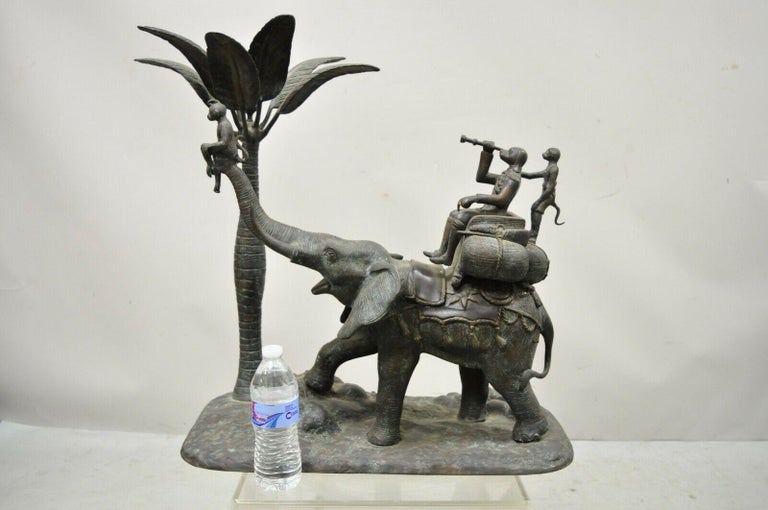 Maitland Smith large bronze monkey palm leaf tree sculpture candle holder. Item features large impressive size, cast bronze figure of 3 monkeys riding on an elephant and a palm tree candle holder. Approx. 55 lbs. Maitland Smith label no longer