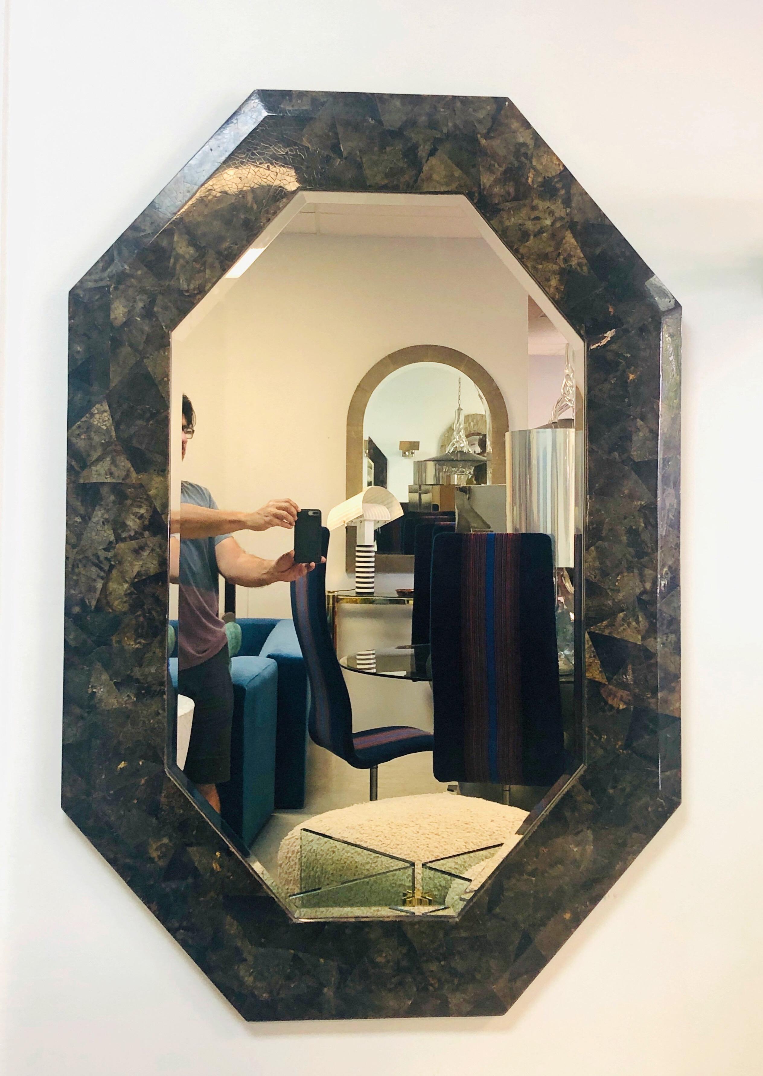A large Maitland Smith wall mirror. Octagonal shape, can hang vertically as well as horizontally. Mirror is beveled.