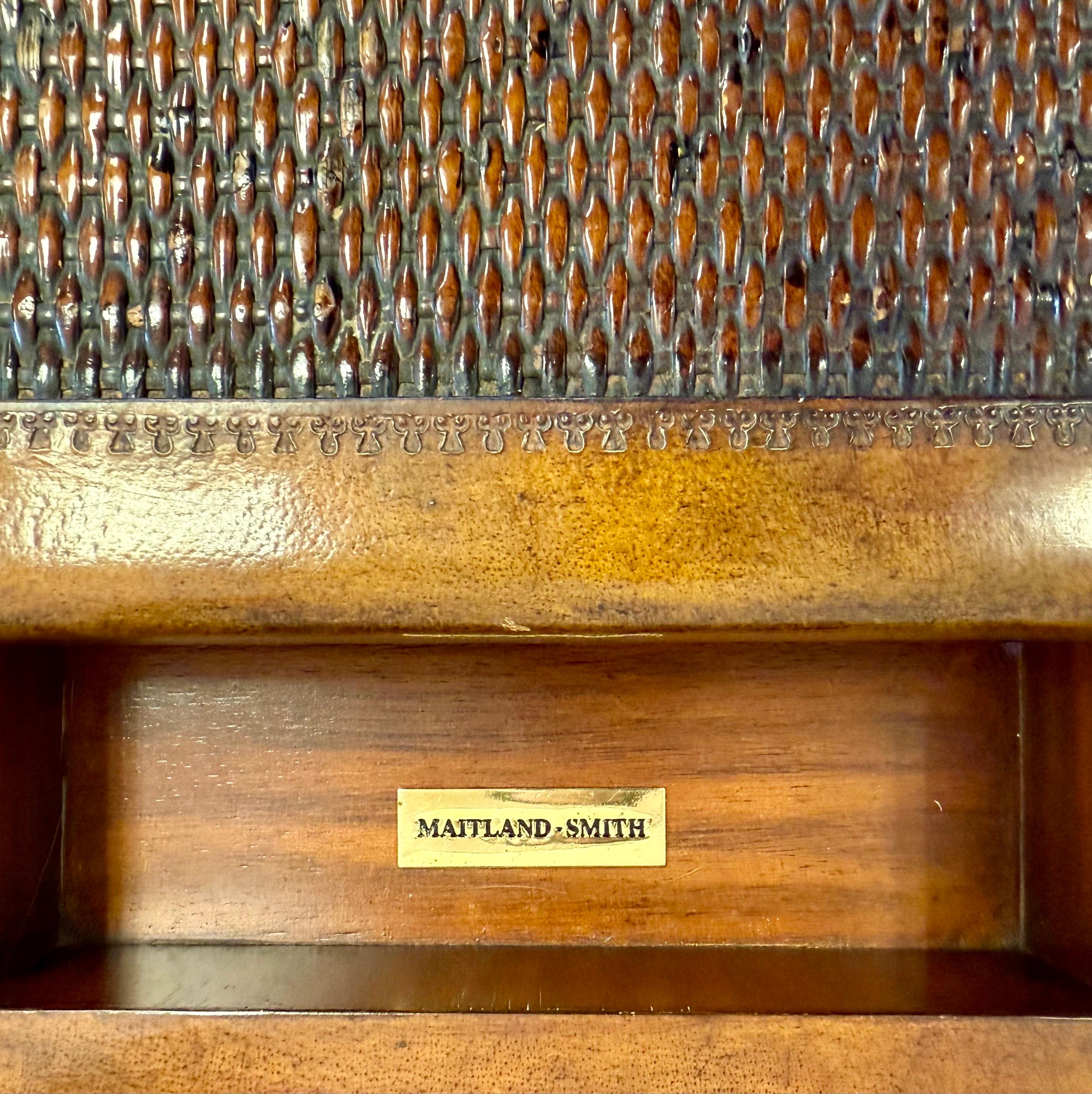 Signed campaign style cocktail table and game table in one by Maitland Smith.  The top is richly covered with leather and rattan and features a floating game board with checkers on one side and backgammon on the other.  Replete with classic campaign