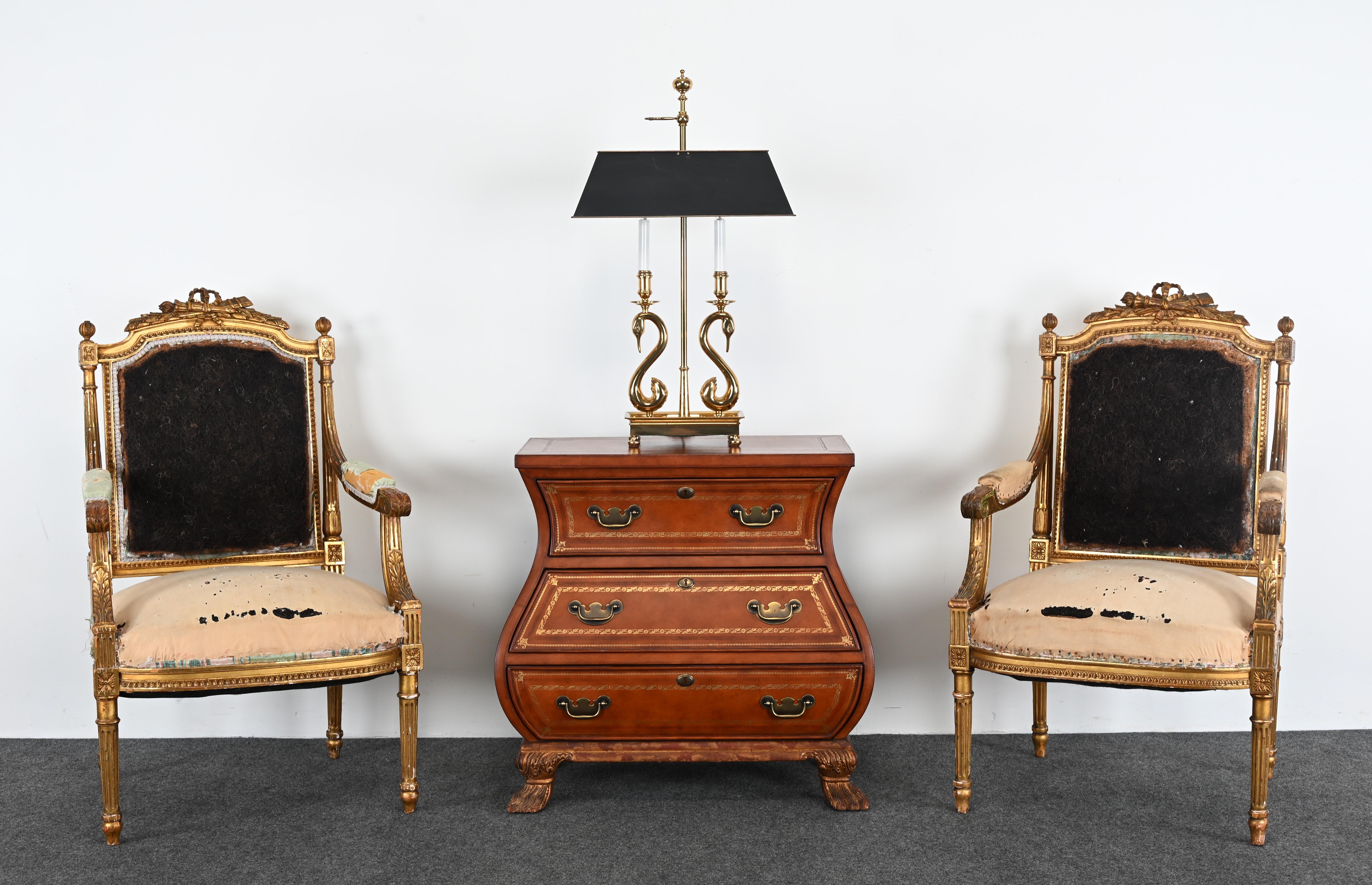 This elegant Maitland Smith bombe-style chest embodies the luxurious craftsmanship synonymous with the brand, featuring a distinctive Baker-inspired design. Crafted with a rich leather-inlaid surface in a warm brown tone, the chest showcases a