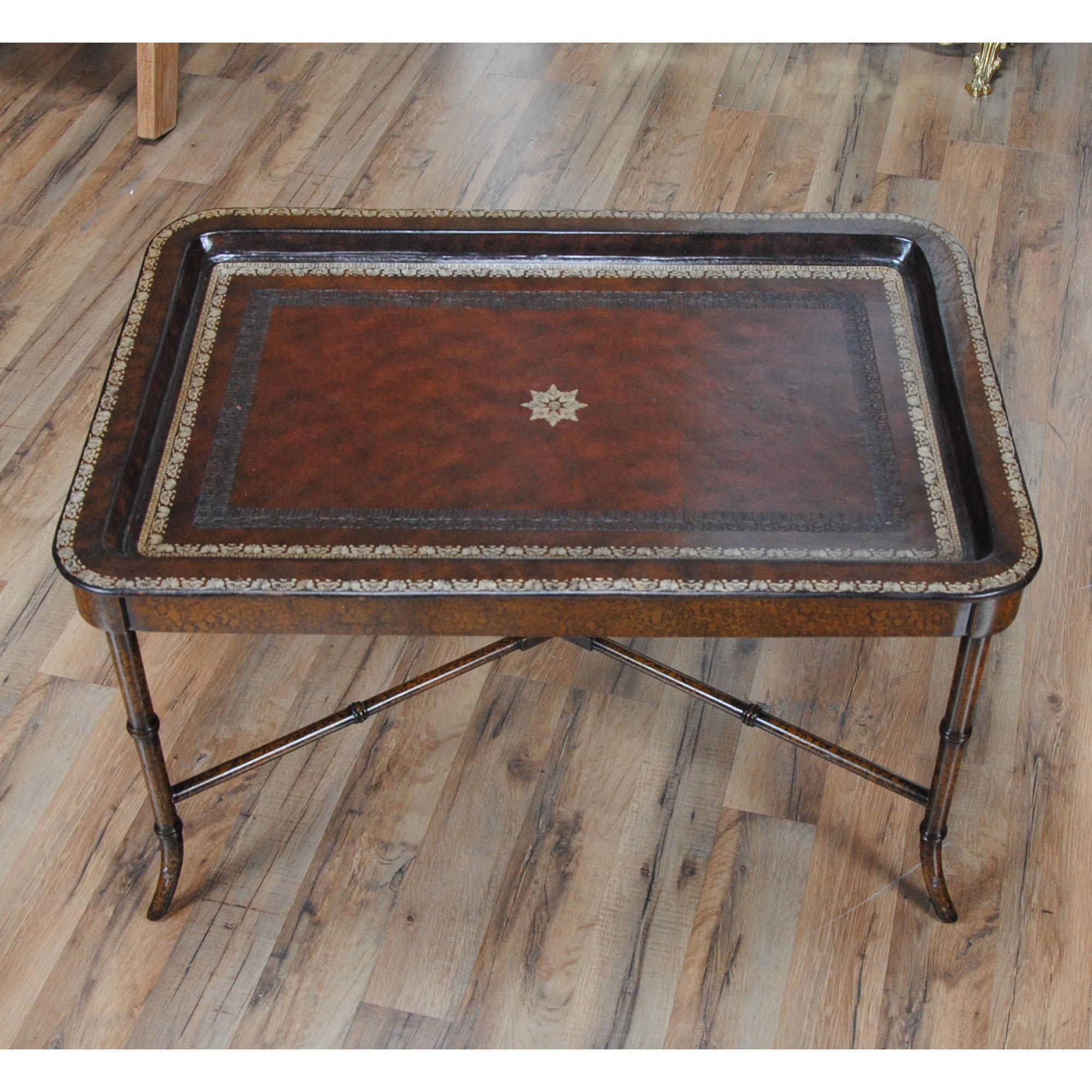 From Niagara Furniture, a Maitland Smith Leather Top Serving Table in excellent condition, featuring a remarkably tooled, removable leather top which doubles as a serving tray. Both elegant and incredibly detailed this beautiful Maitland Smith