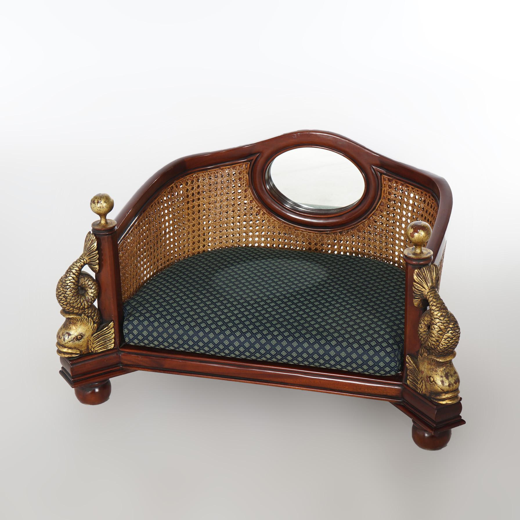 A Maitland-Smith pet bed offers mahogany frame with caned back and flanking giltwood dolphins, upholstered seat, and raised on ball feet, without maker label, 20th century

Measures- 18.5''H x 34''W x 23.5''D

Catalogue Note: Ask about DISCOUNTED