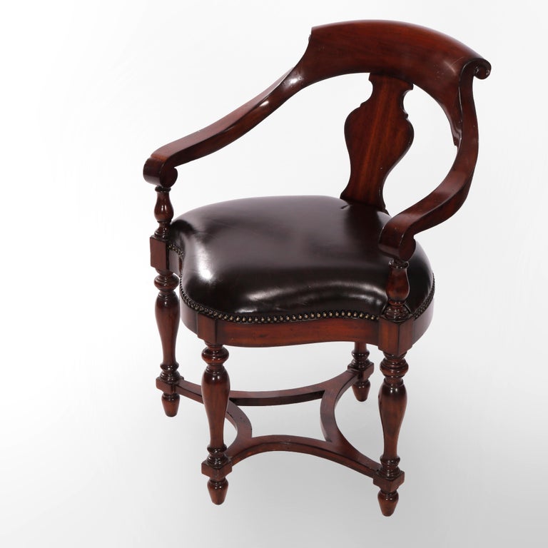 A corner arm chair by Maitland Smith offers mahogany frame with scrolled rail over urn form slat back, scroll form arms, leather upholstered shaped seat, raised on balustrade legs, maker label as photographed, 20th century

Measures - 33.5'' H x