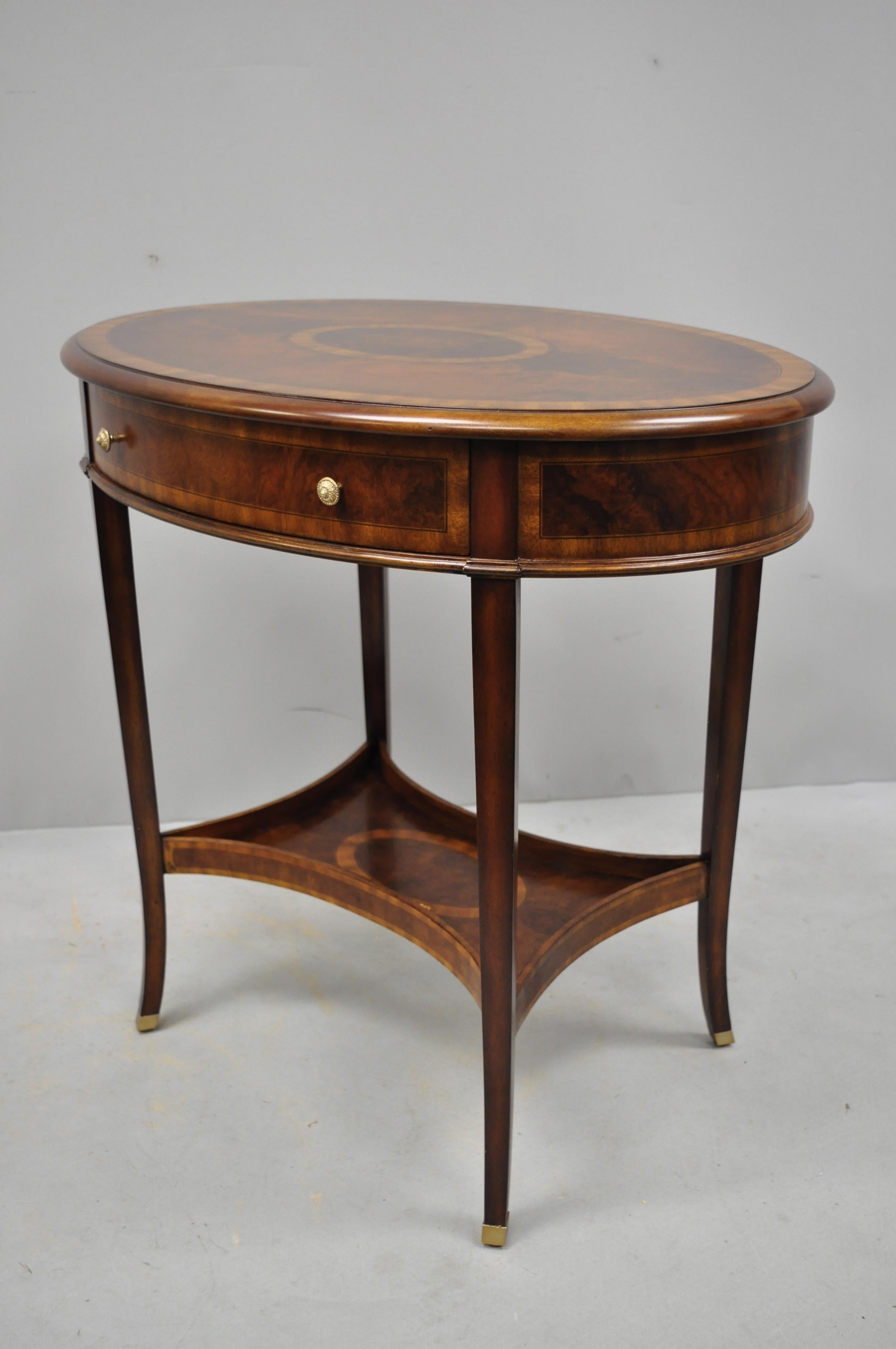 Maitland Smith mahogany oval inlaid one drawer occasional accent side table. Item features beautiful wood grain, original label, 1 drawer, tapered legs, nice inlay, great style and form, circa 20th-21st century. Measurements: 28