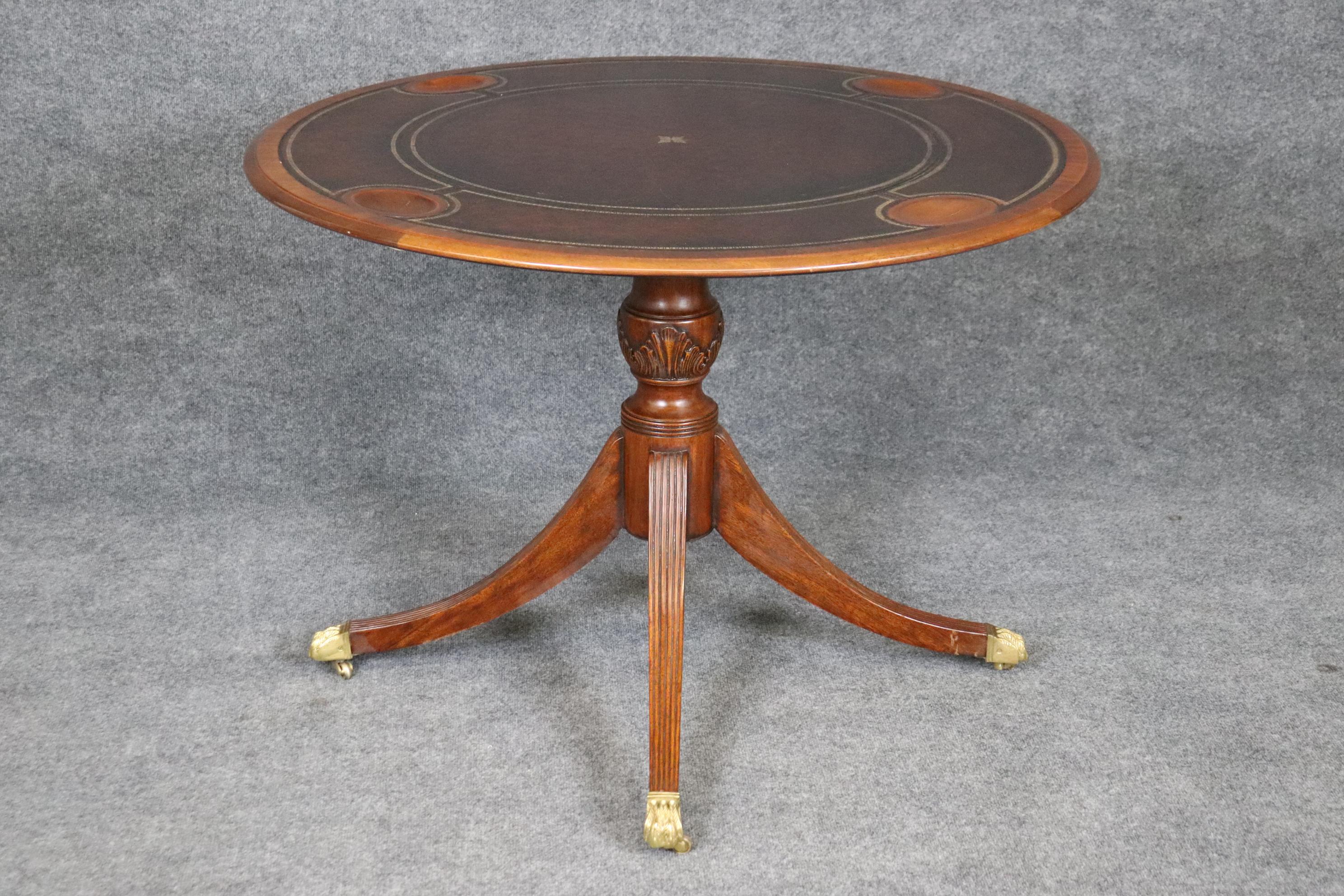 This is a gorgeous Maitland Smith tilt-top leather card or games table. The table features scooped areas for chips or cards and a beautiful leather top with burgundy and gold embossing. The table is in good condition and will have signs of use and