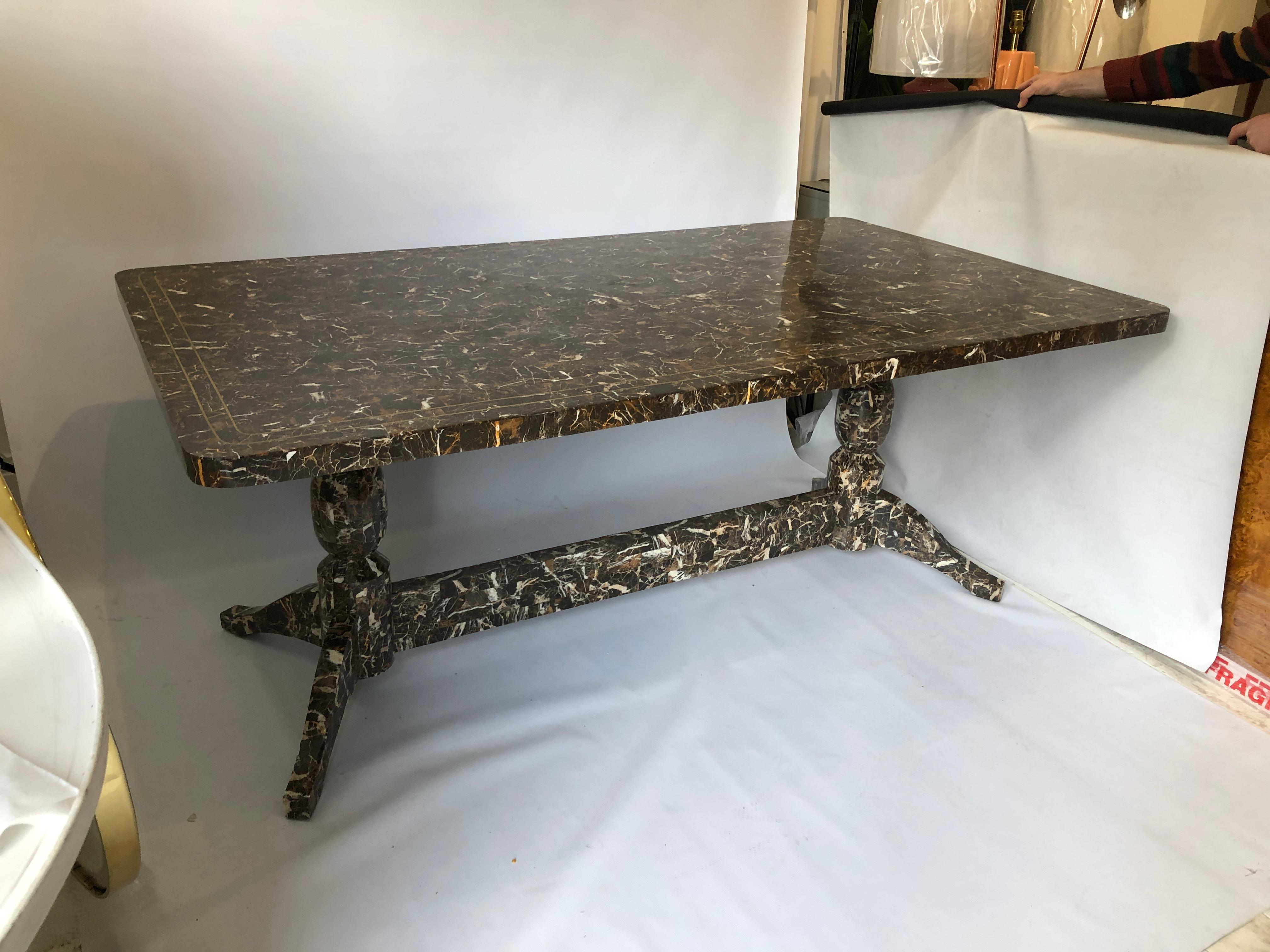A beautifully 1980s extra-large marble dining table from Maitland-Smith, the renowned American furniture company. This piece consists of tessellated Emperador marble rectangles, placed together to create a dazzling and distinct pattern surface of