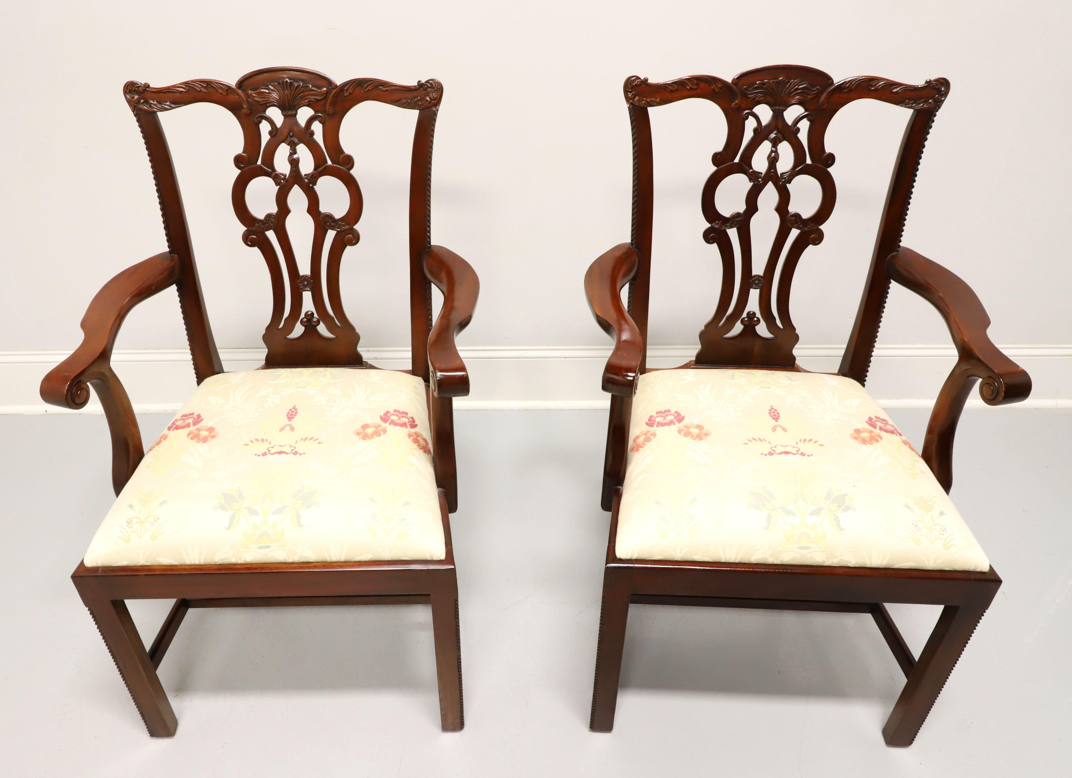 A pair of Chippendale style dining armchairs by Maitland Smith, their Massachusetts. Solid mahogany with decoratively carved crest rail, back rest, curved scroll arms, carved beading to edge of stiles & edges of the front straight legs with