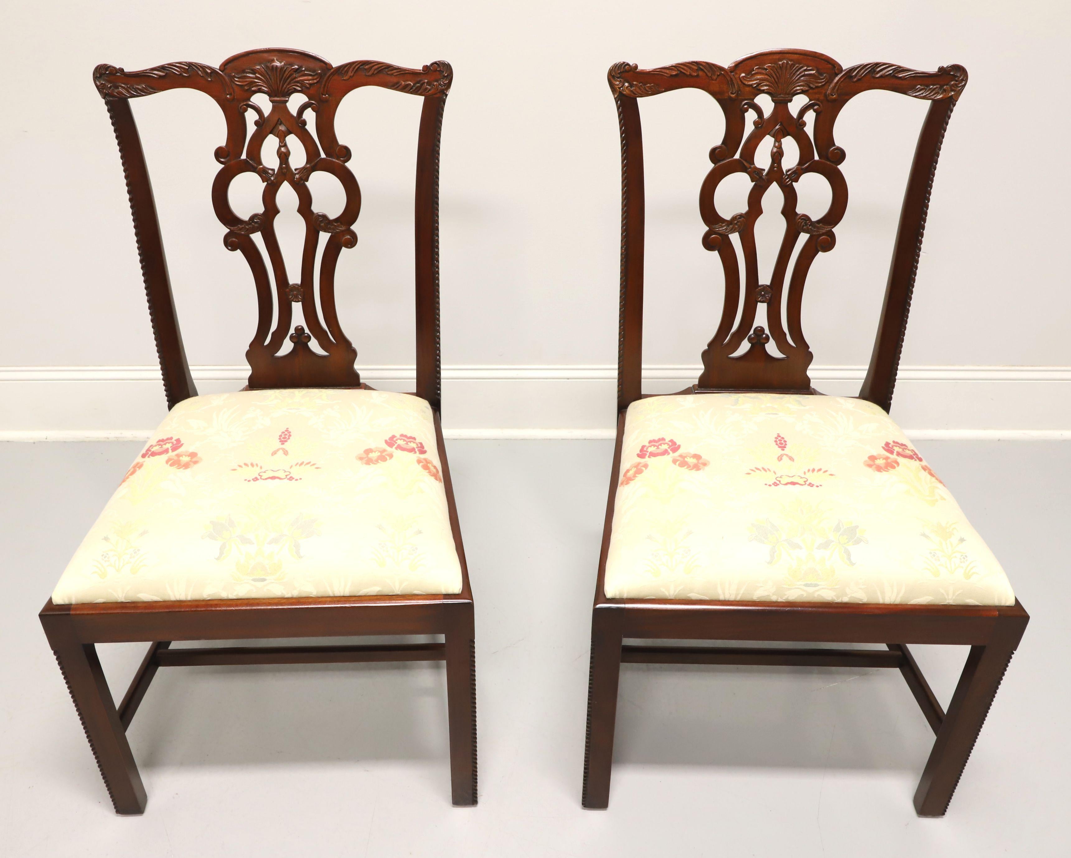 A pair of Chippendale style dining side chairs by Maitland Smith, their Massachusetts. Solid mahogany with decoratively carved crest rail, back rest, carved beading to edge of stiles & edges of the front straight legs with stretchers. Seat