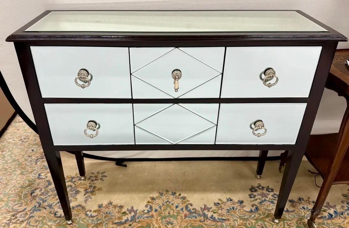 Maitland Smith mirrored console/dry bar that oozes sophistication and functionality with its mirrored finish and lacquered frame.  Features three drawers over one drawer as shown.  All Maitland Smith hallmarks are present.  Iconic in every way.  Why