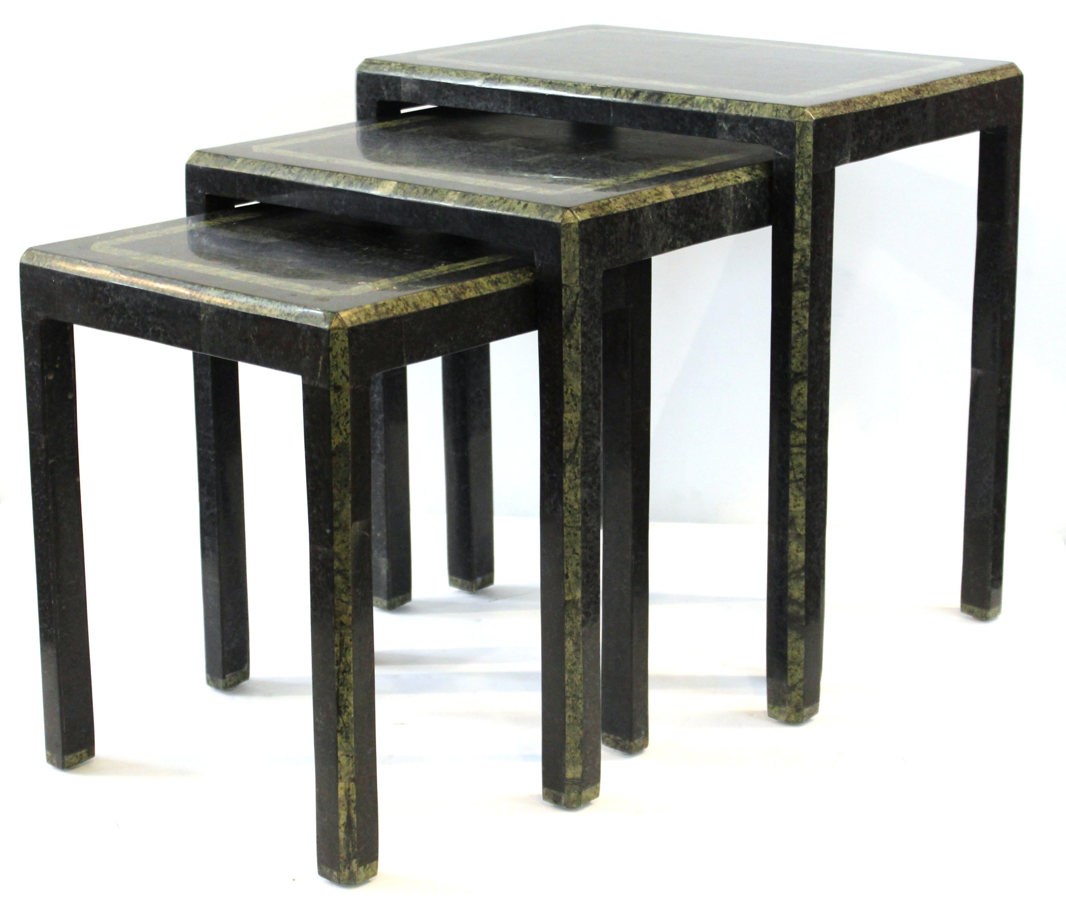 Set of modern nesting tables designed by Maitland-Smith with tessellated polished stone surfaces. Made in the mid-late 20th century. The three tables are in great vintage condition with age-appropriate wear and use.