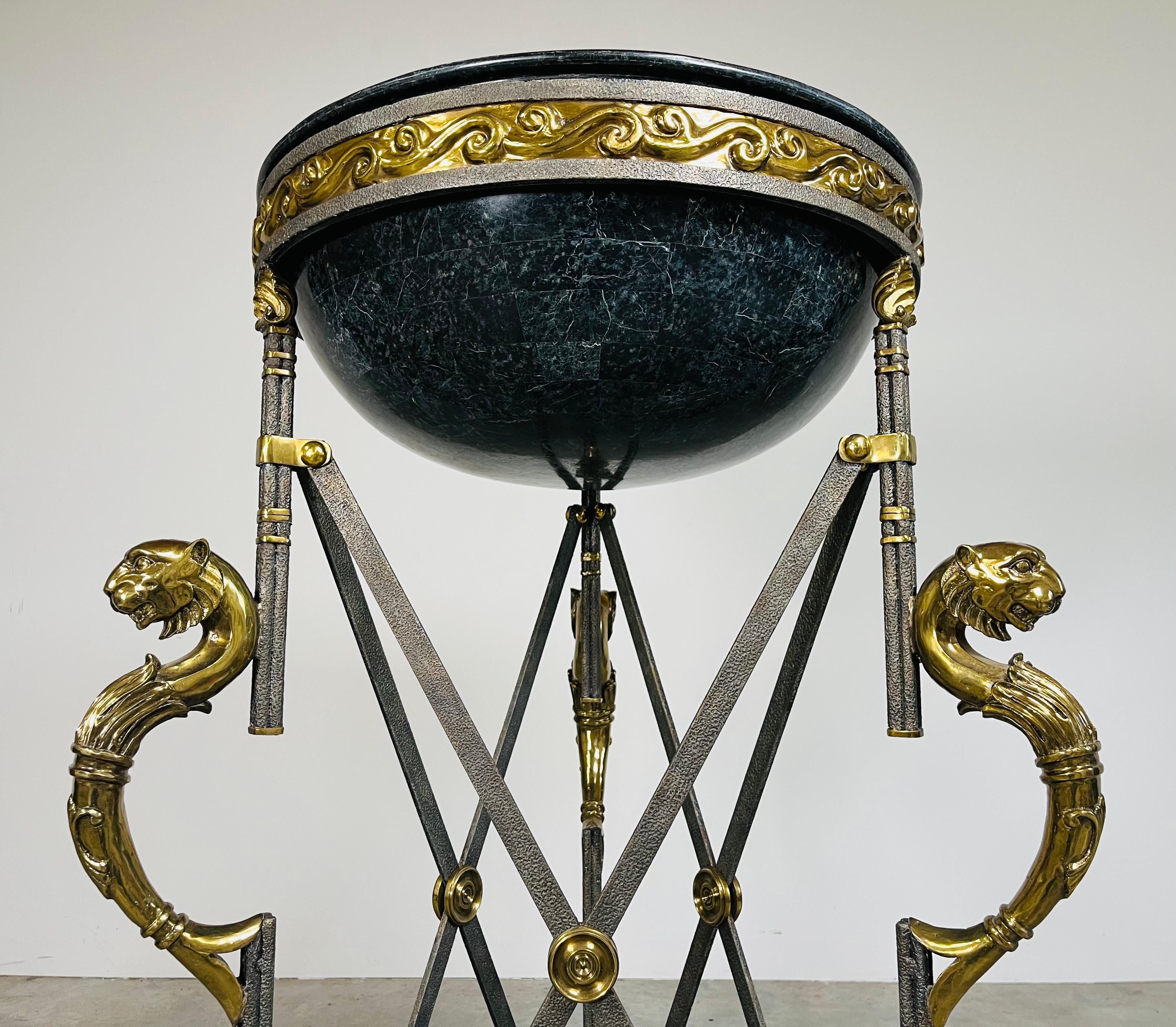 An impressive cauldron or planter by Maitland-Smith made from iron and bronze in Neoclassical, French Empire and Egyptian styling. Features a 21.5” diameter tessellated planter bowl in Verde green over an impressive 3-leg base connected by X form