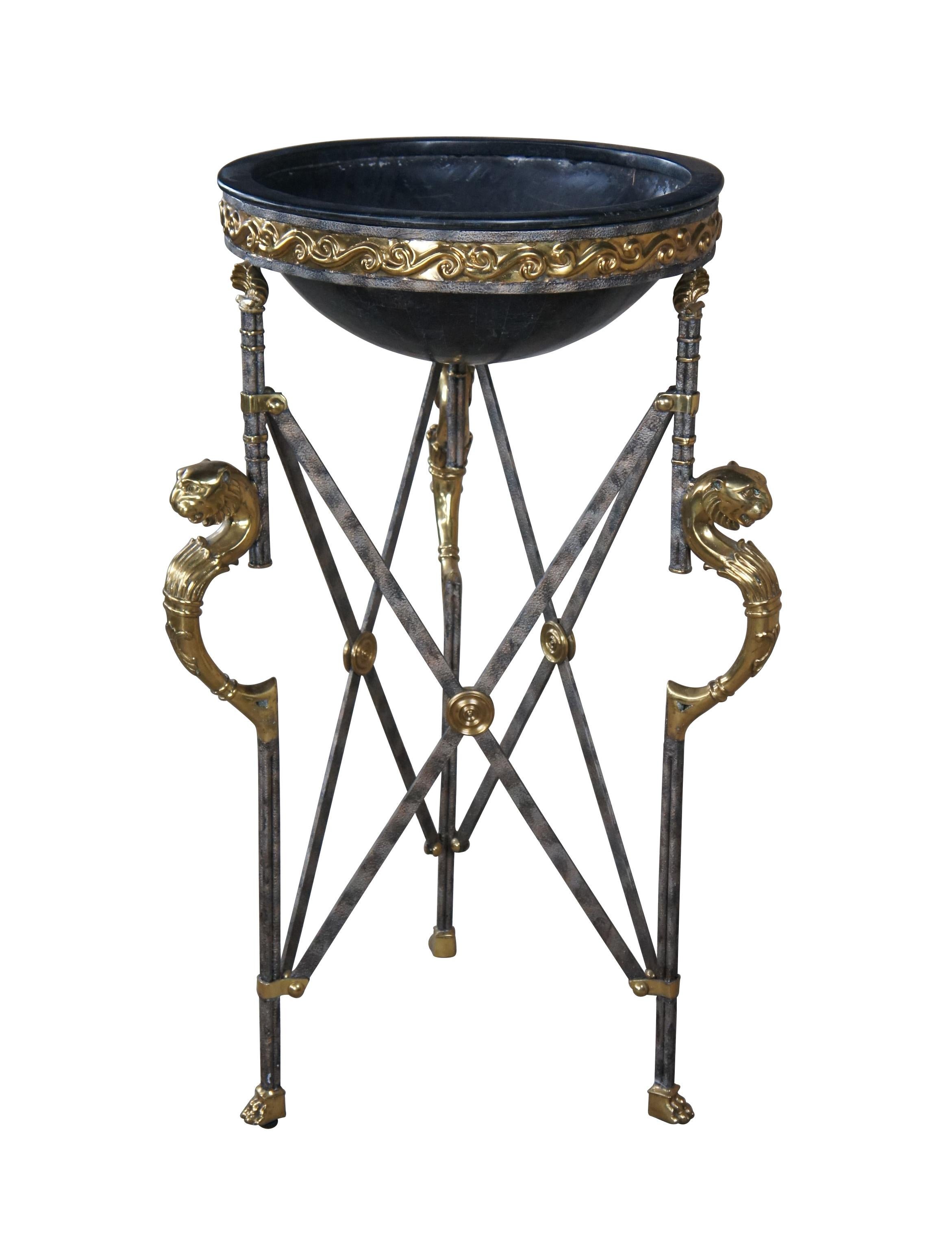 An impressive cauldron or planter by Maitland-Smith, circa 1990s.  Made from iron and bronze in Neoclassical, French Empire and Egyptian styling.  Features an iron tripod base connected by X form stretchers with bronze accents.  Each leg has an