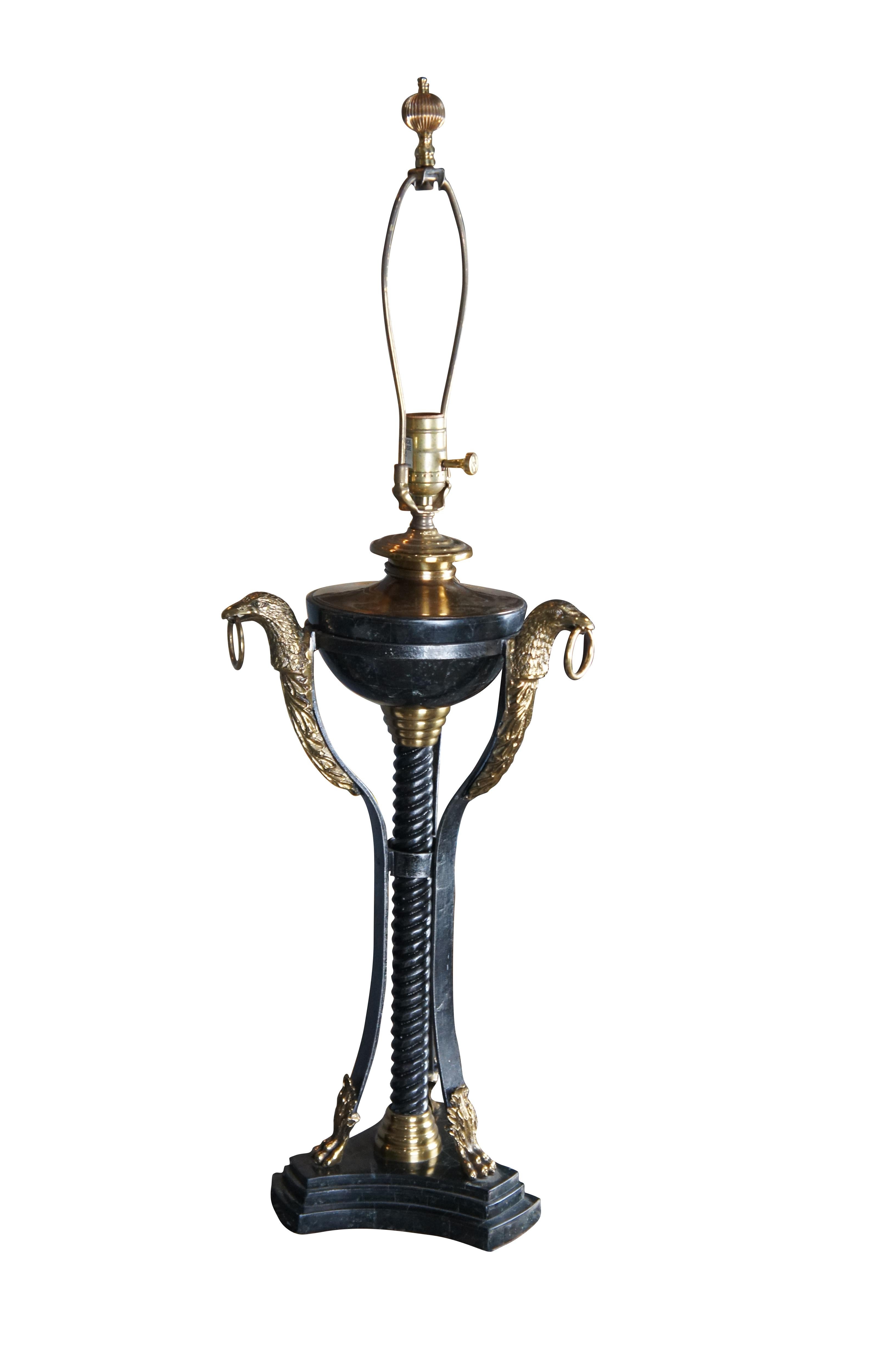Late 20th century, iron, brass and tessellated marble table lamp by Maitland Smith. Features an oil urn shaped body over twisted iron supports and stepped tripod plinth base. The urn portion is connected to three brass eagle heads supports leading