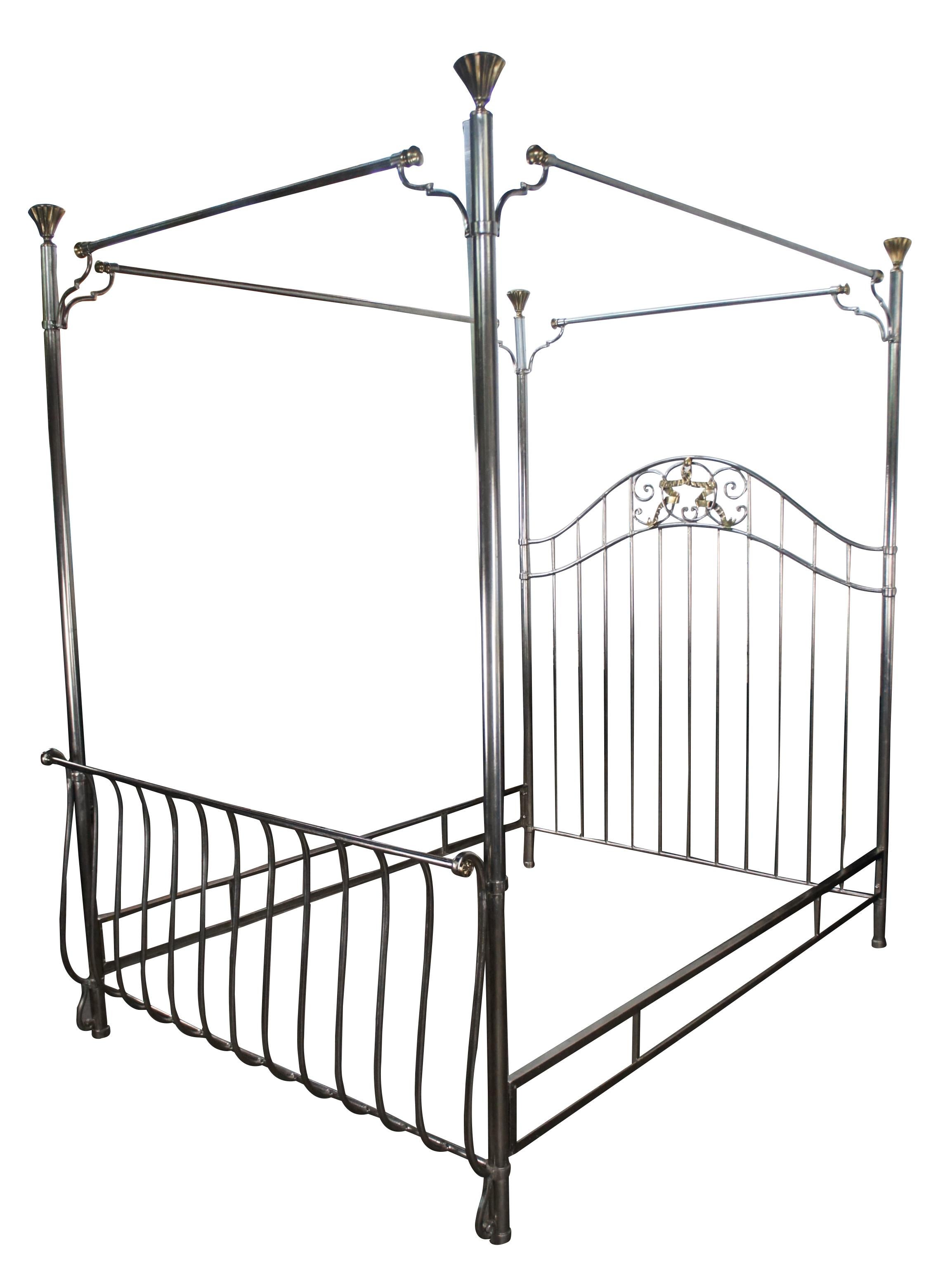 Maitland Smith Neoclassical style four poster Queen size canopy bed, circa 1990s.  Made from metal with a silver and gold finish.  Features a sleigh form along the front and camelback headboard with ornate scrolling and laurel wreath at the center. 