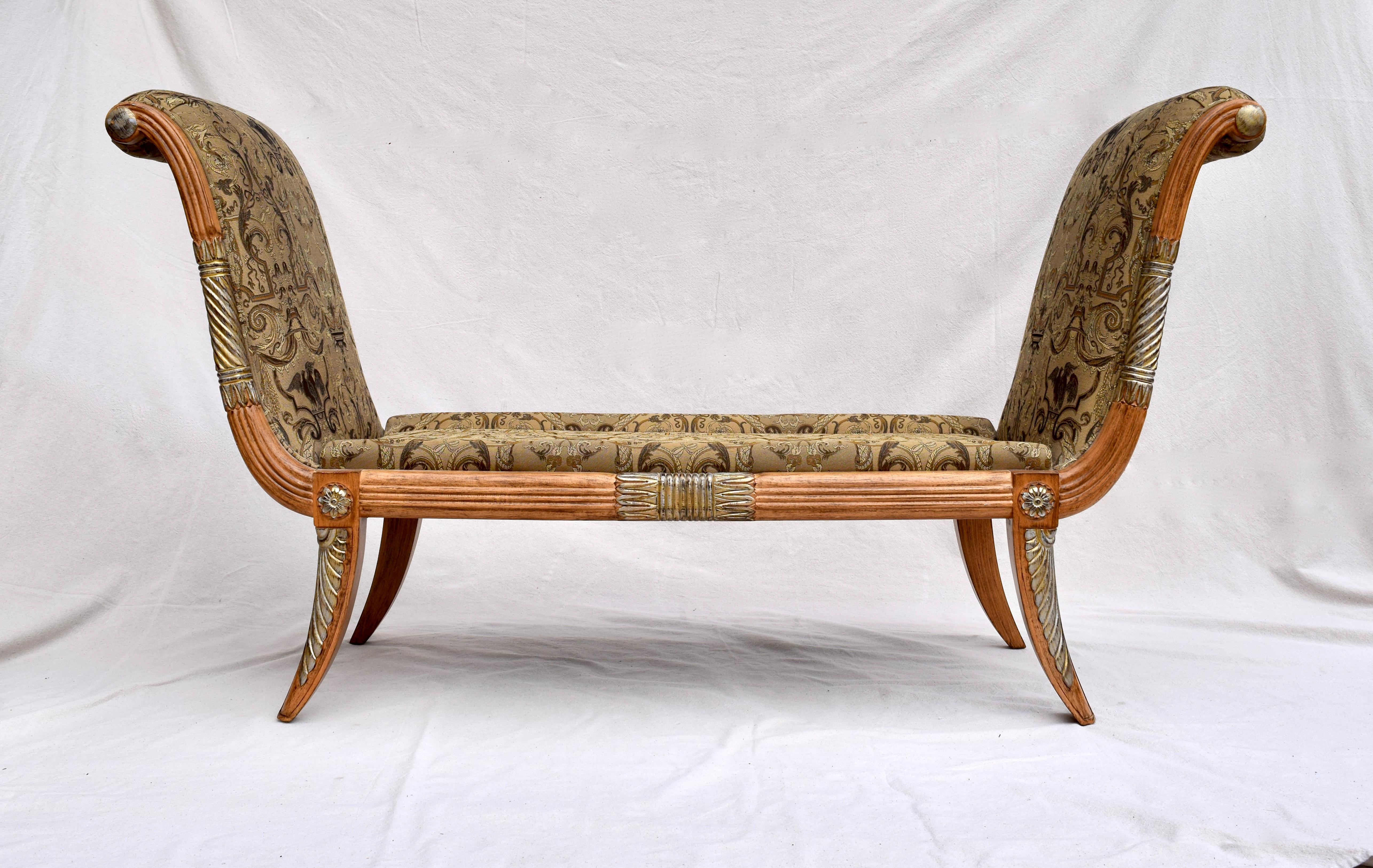 Maitland Smith neoclassical style Recamiere settee or scroll arm bench with reed carved body and splayed legs enhanced with silver leaf accents. Newly upholstered in rich detail damask of classical cherubs and eagle design, the single, loose cushion