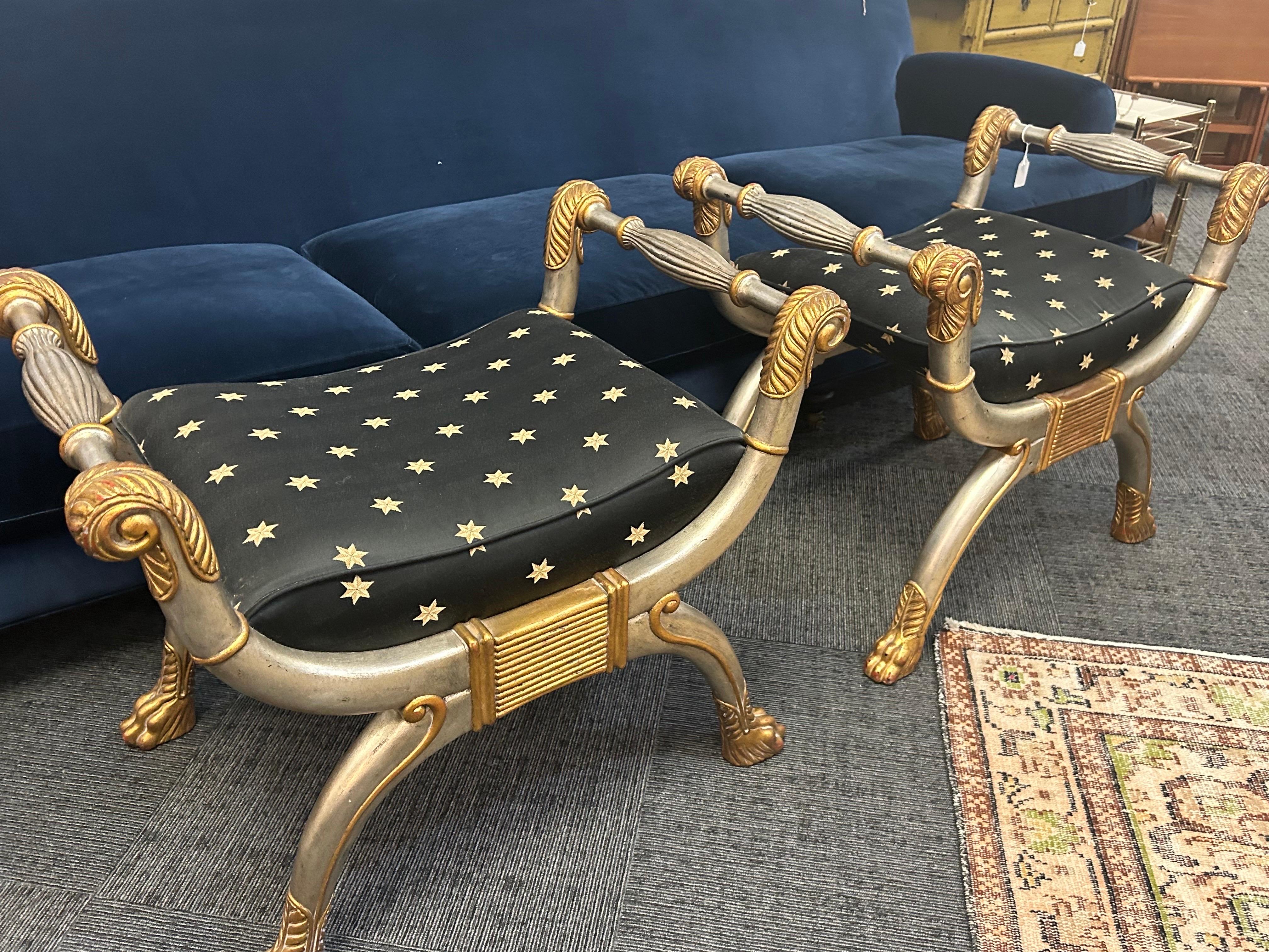 A pair of Maitland  Smith neoclassical style benches  from the 1980s. They are signed and in very good condition.. the fabric with stars is a perfect match for the silver gilt  finish… 26H x  30 ““W x 21” Deep the seat height is 19 inches..