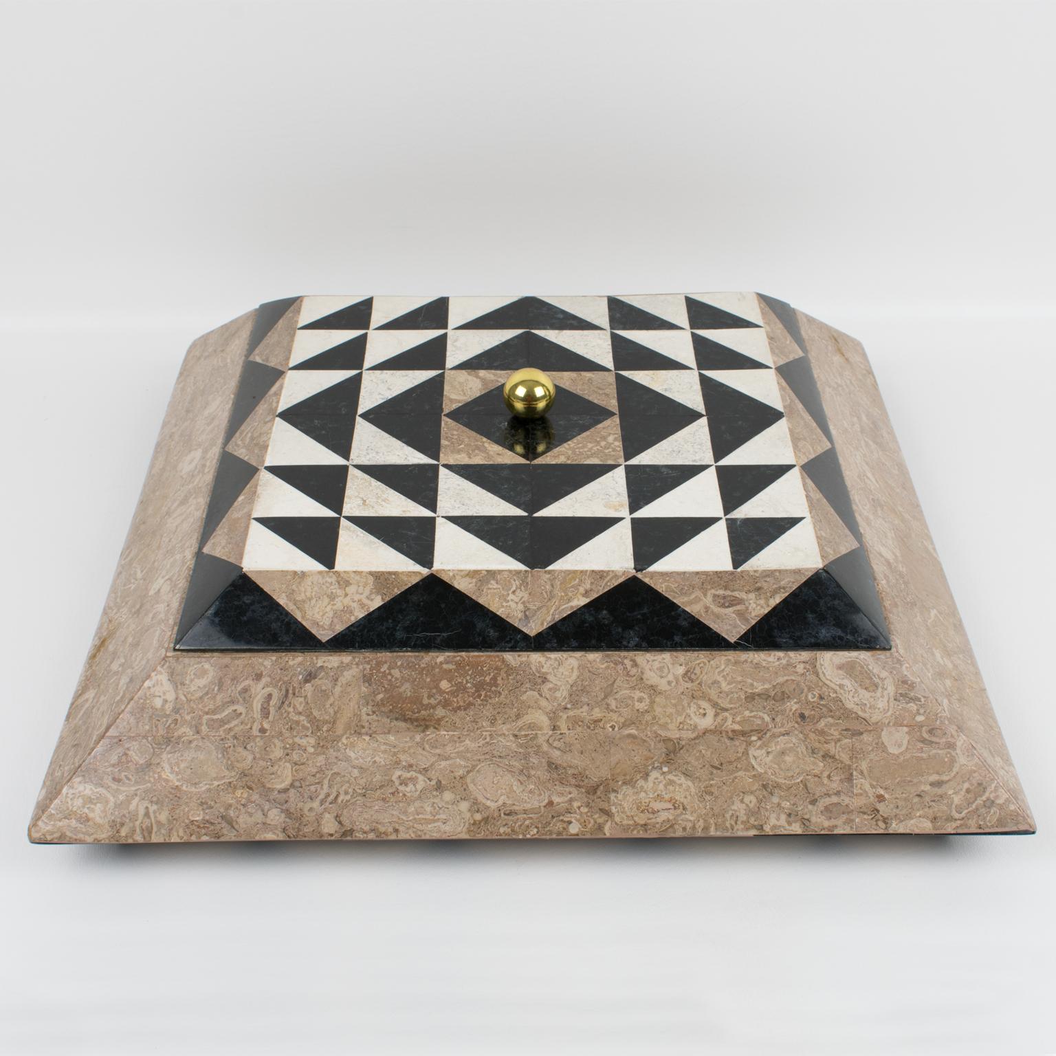 A spectacular lidded box designed by Maitland-Smith in the 1980s, rendered in tessellated marble, stone, travertine, and brass. The pyramidal square-shaped design boasts sand beige, black, and off-white colors with an interesting geometric
