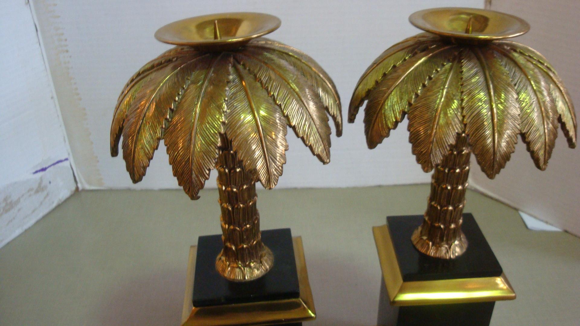This is a pair of Maitland Smith brass and tesselated black stone palm tree candlesticks.