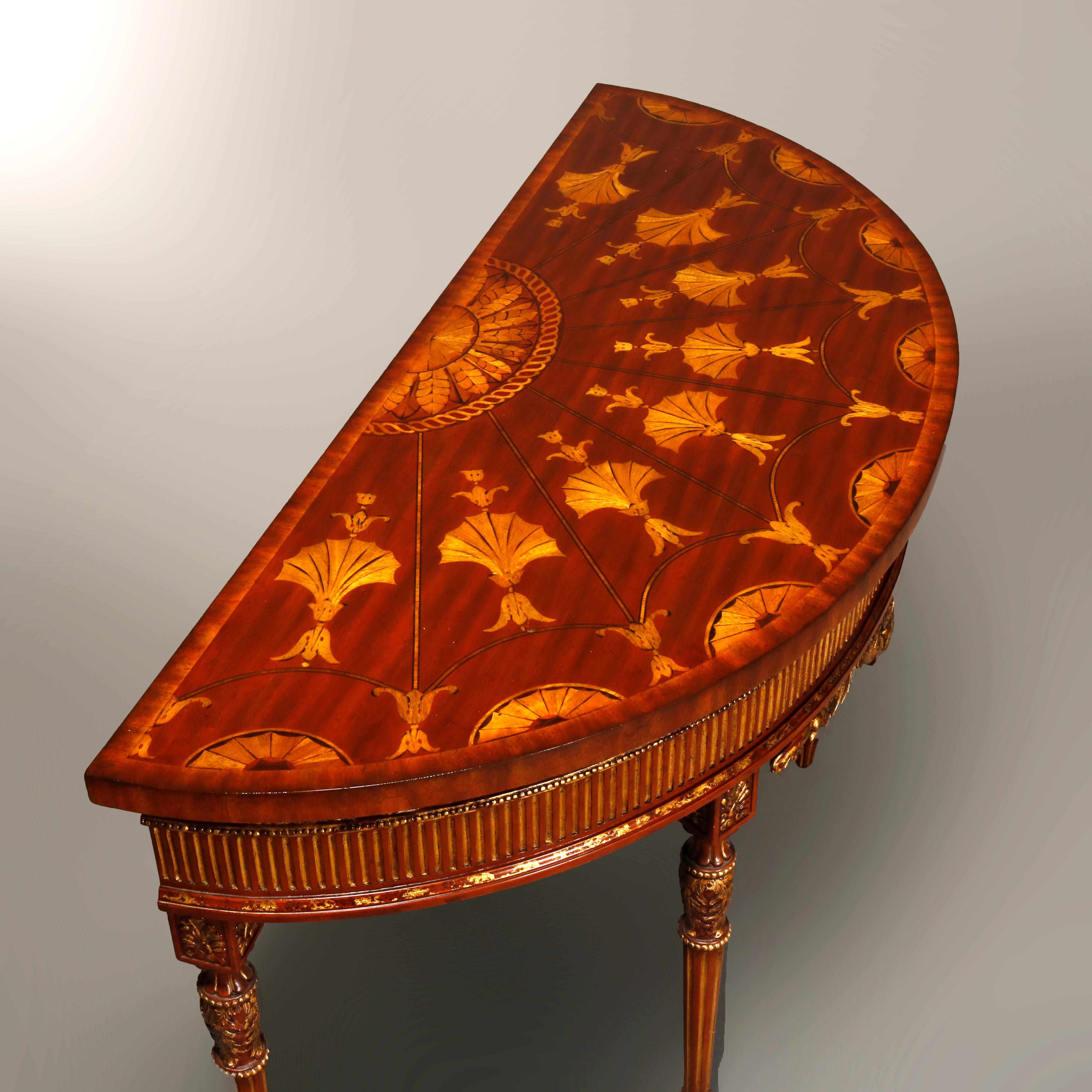 A console table by Maitland Smith offers demilune form with marquetry top having sunburst pattern of inlaid satinwood stylized fan and foliate elements, parcel gilt reeded skirt with acanthus, beaded and shell trim, raised on carved tapered and