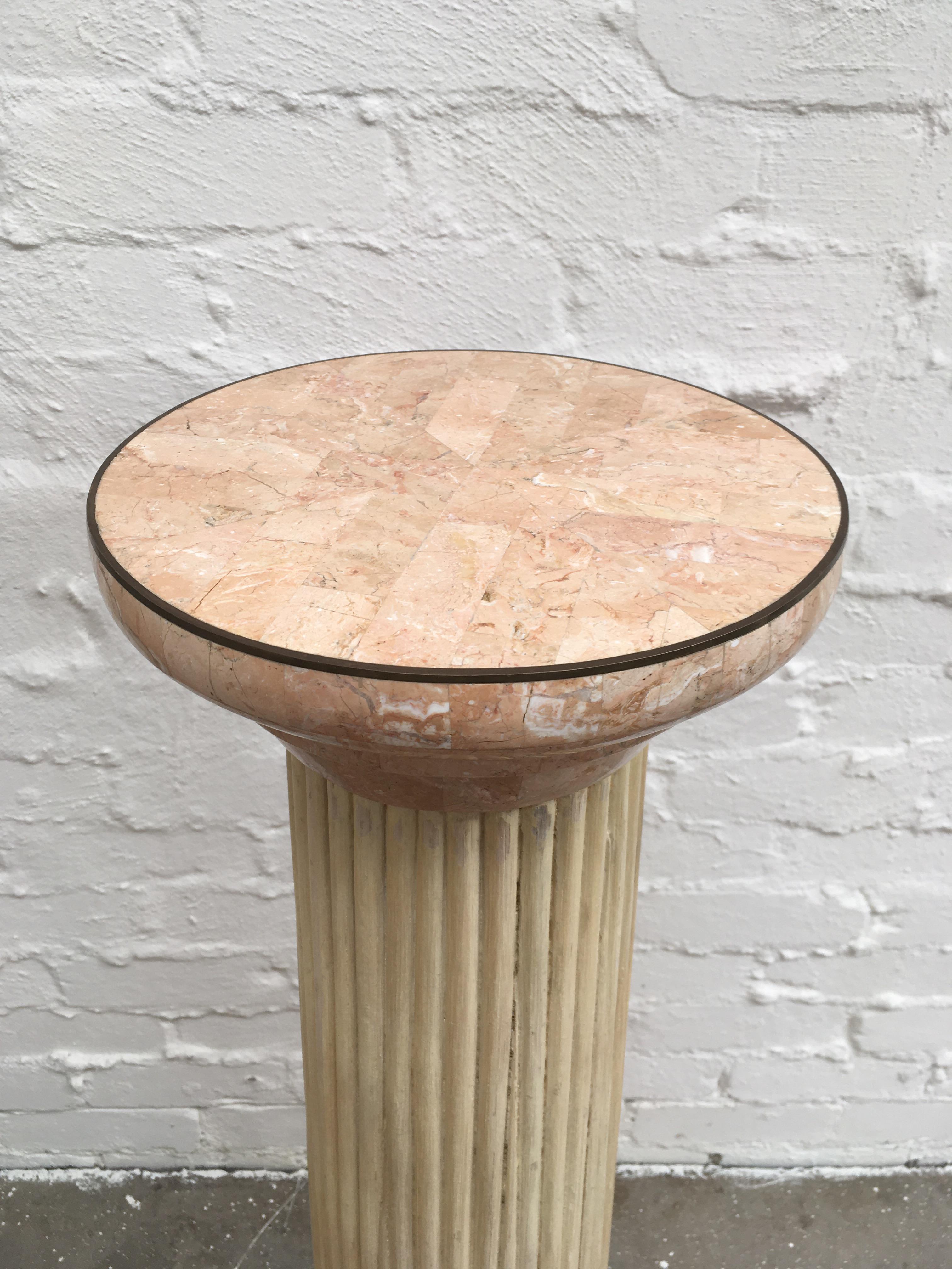 A 1970s tessellated marble and rattan pedestal in the form of a simple Doric order column with the rattan construction forming a 'fluted' finish. 

Beautiful pink tessellated stone with brass reinforcement on all edges. This is clearly an item of