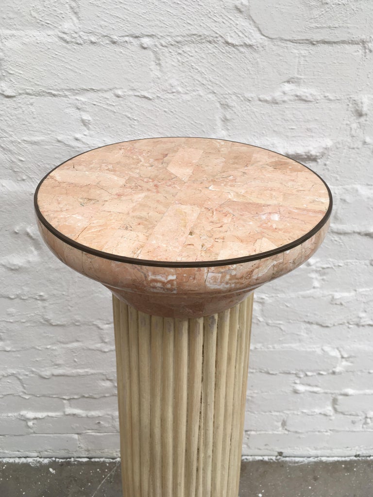 A 1970s tessellated marble and rattan pedestal in the form of a simple Doric order column with the rattan construction forming a 'fluted' finish. 

Beautiful pink tessellated stone with brass reinforcement on all edges. This is clearly an item of