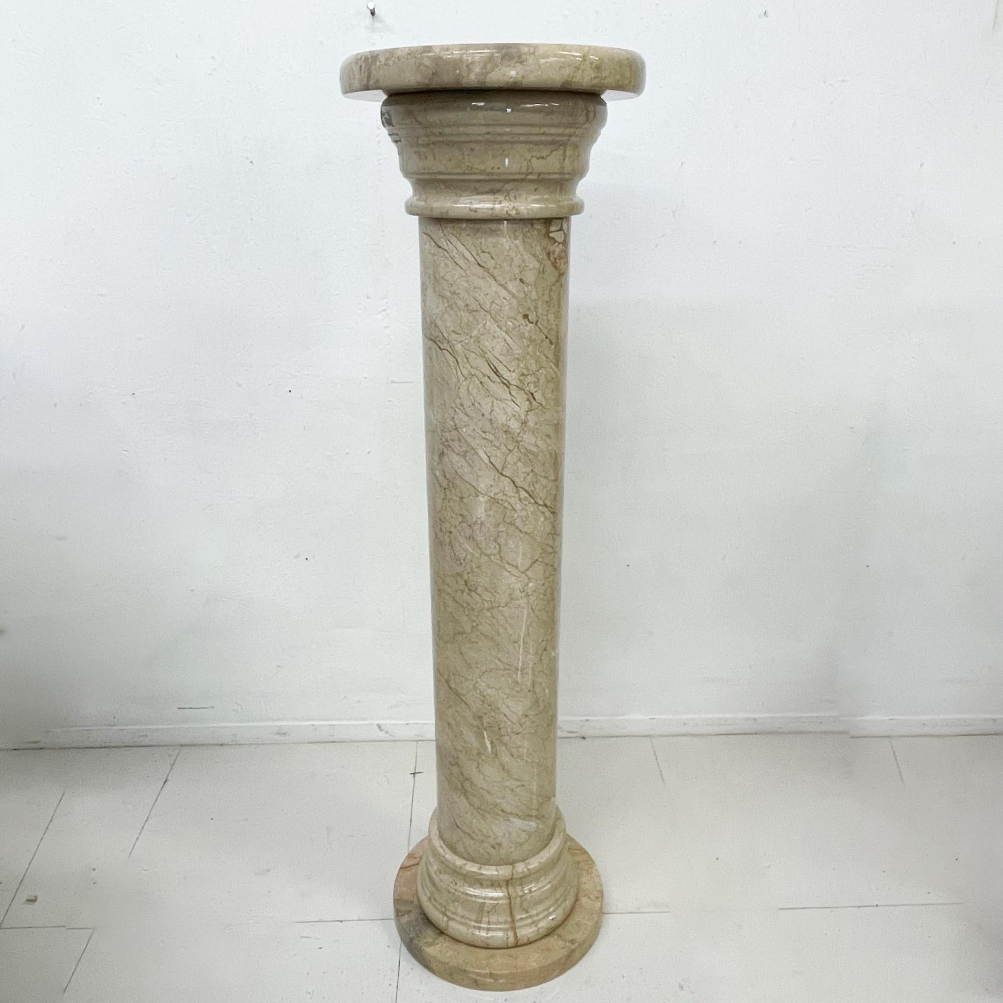 Stone Pedestal
1980s Post Modern Maitland Smith Stone pedestal Column in warm beige with round plinth base. 
Polished Marbled Stone Pedestal attributed to Maitland Smith style of Karl Springer 
Unmarked.
60.25 Tall x 16.75 in diameter