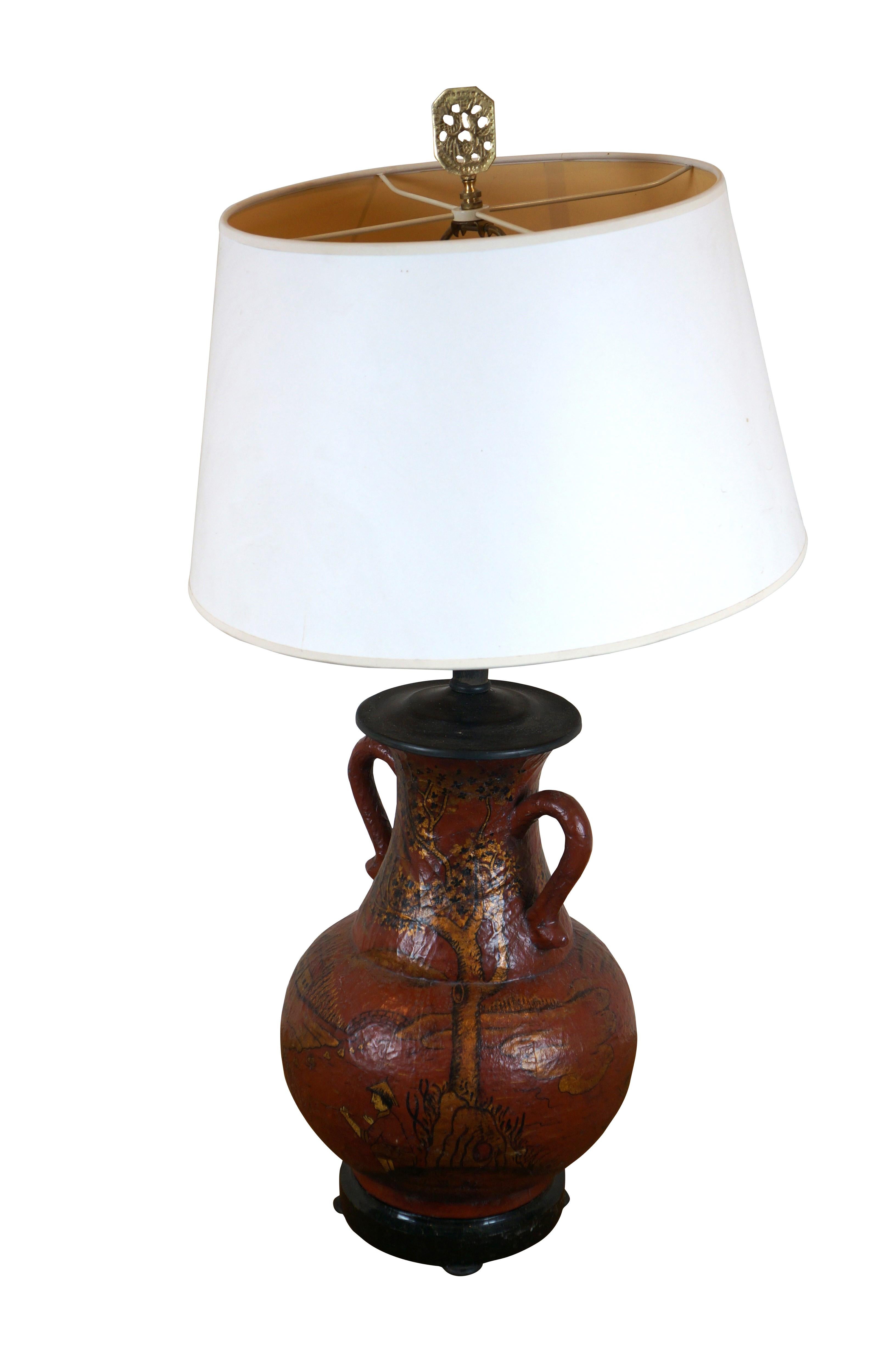 Maitland Smith, circa 1990s, vase / vessel / urn / jug shaped Chinoiserie table lamp featuring red coromandel style lacquer finish with a painted landscape / fishing scene in gold and balck, and black tesselated stone base. Includes harp, white