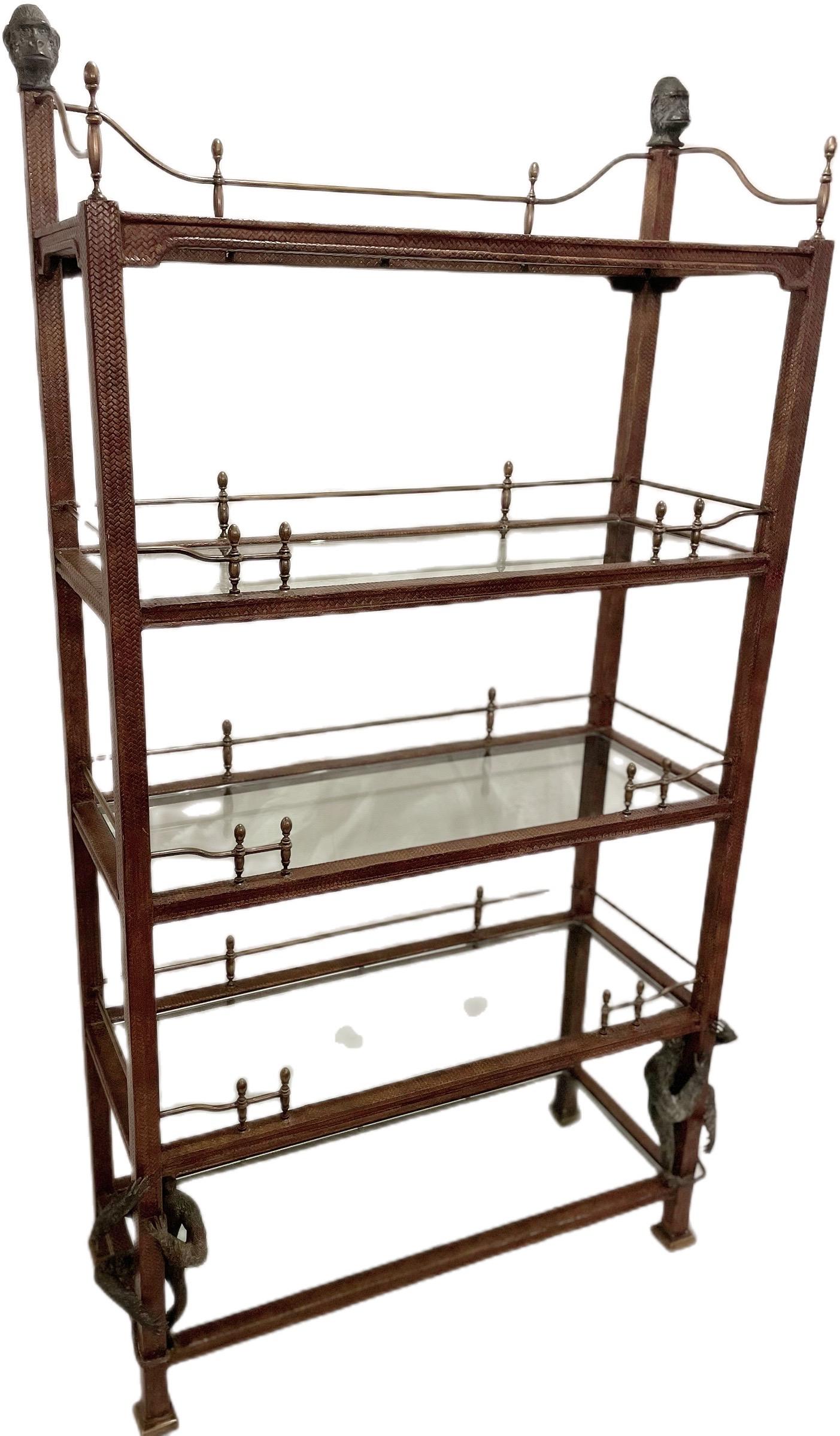Extremely rare and exquisitely crafted Maitland -Smith late 20th Century Sculpted Monkey Bookcase Etagere with 5 shelves. Glass shelves are extremely thick and heavy, coming in at about 3/8 inch thick glass. The dimensions are 43.5