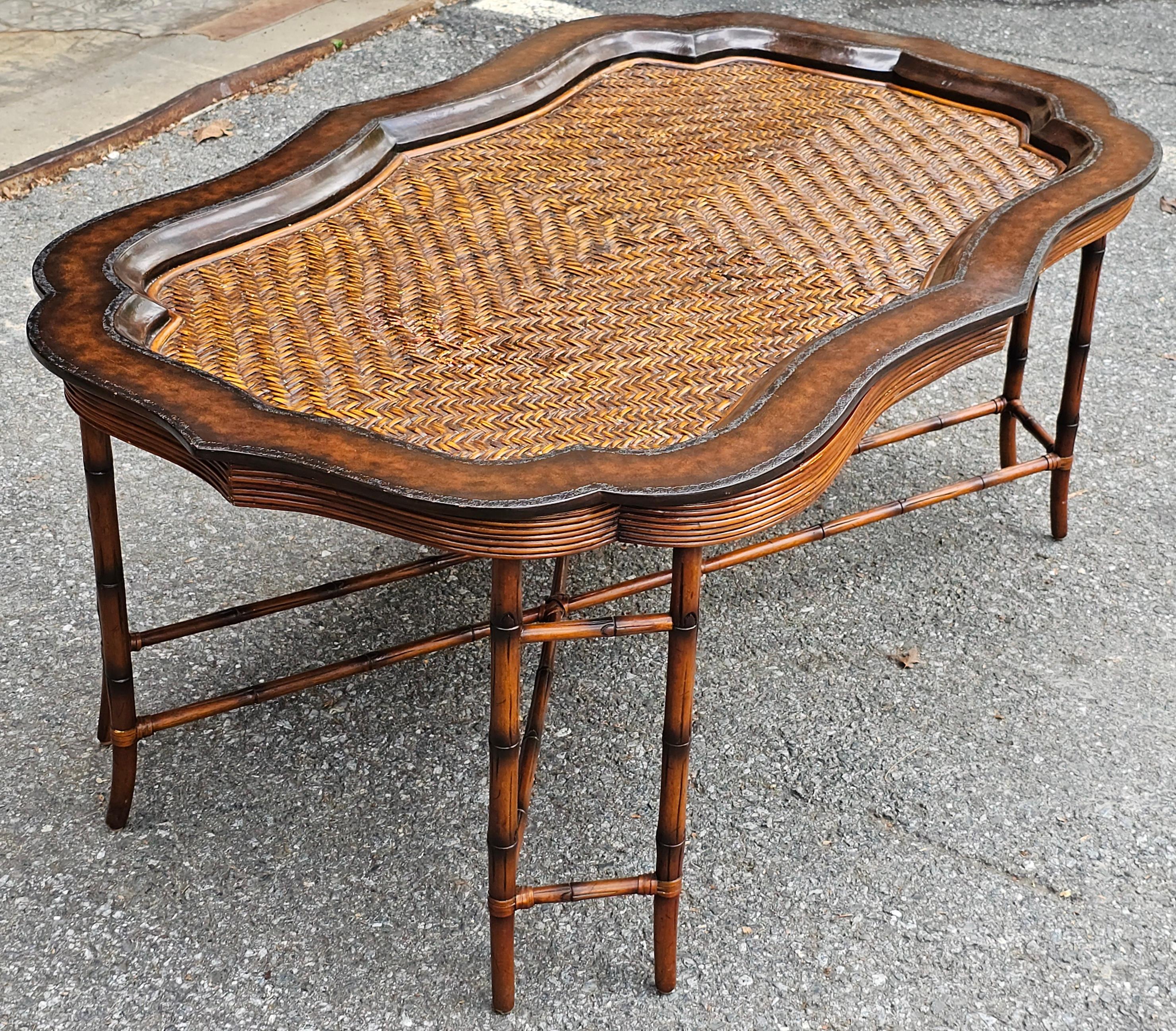 A Maitland-Smith Regency Style Faux Bamboo Base Leather and Wicker Tray Top Coffee Table.
Measures 56 