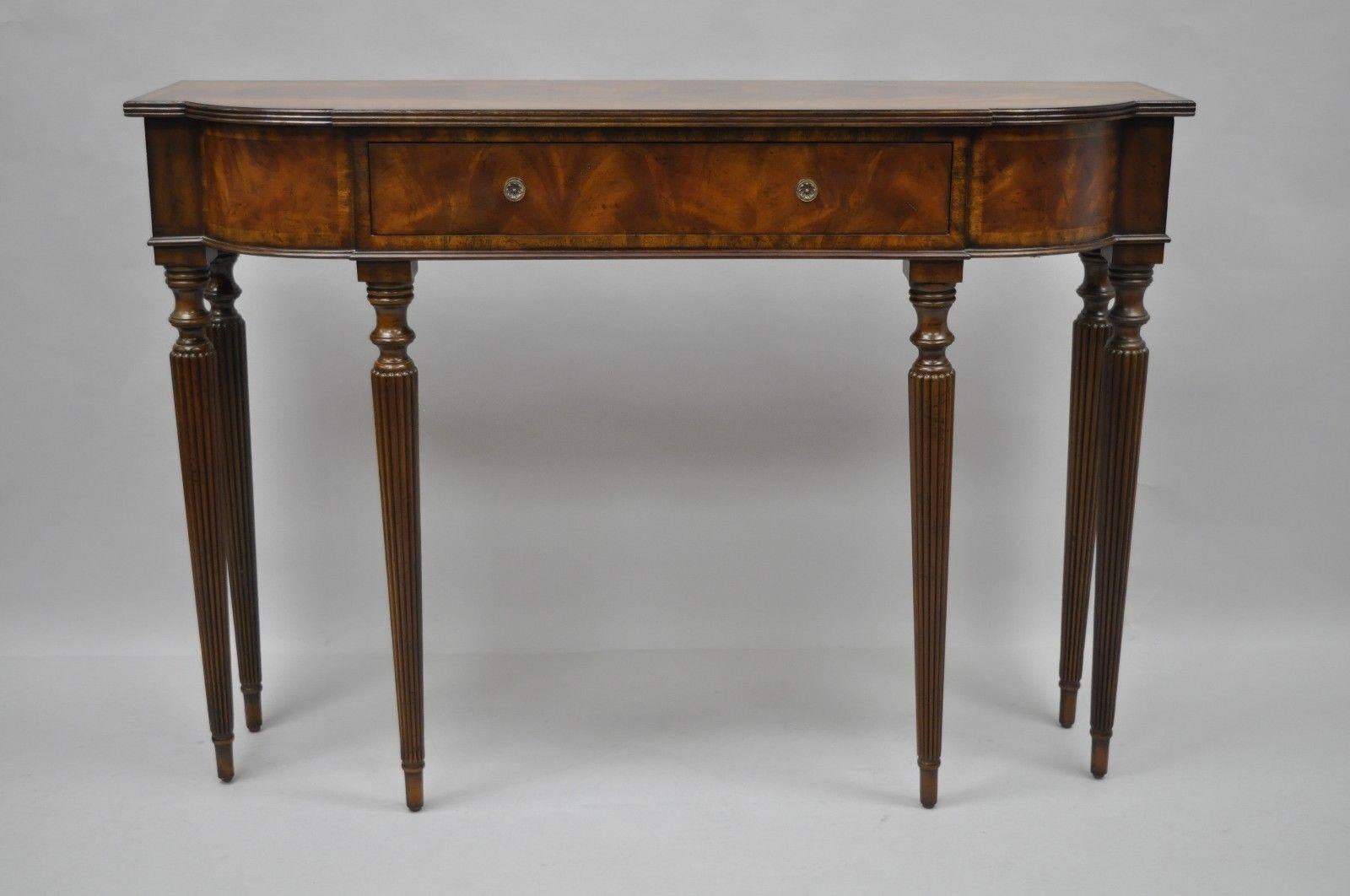 Maitland Smith Regency / Sheraton style mahogany console table. Item features wood construction, single drawer, slender tapered legs, beautiful wood grain, original Maitland Smith labels. Maitland Smith retail price $1,935. 
Brackets to rear of