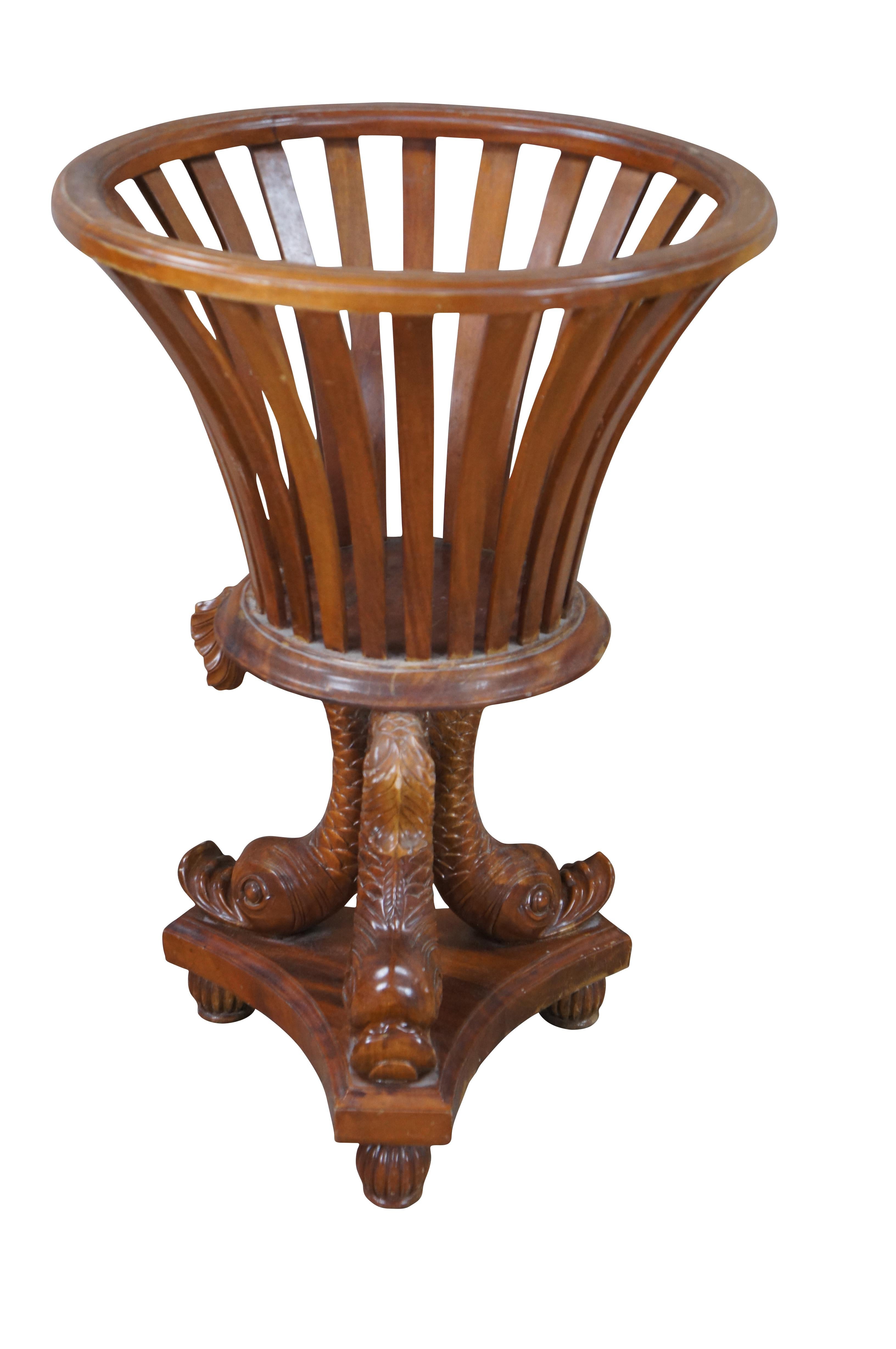 Late 20th Century Maitland Smith jardinière plant stand.  Made from mahogany with a tripod carved delphin base over reeded bun feet and a reticulated planter top.

Dimensions:
19.5