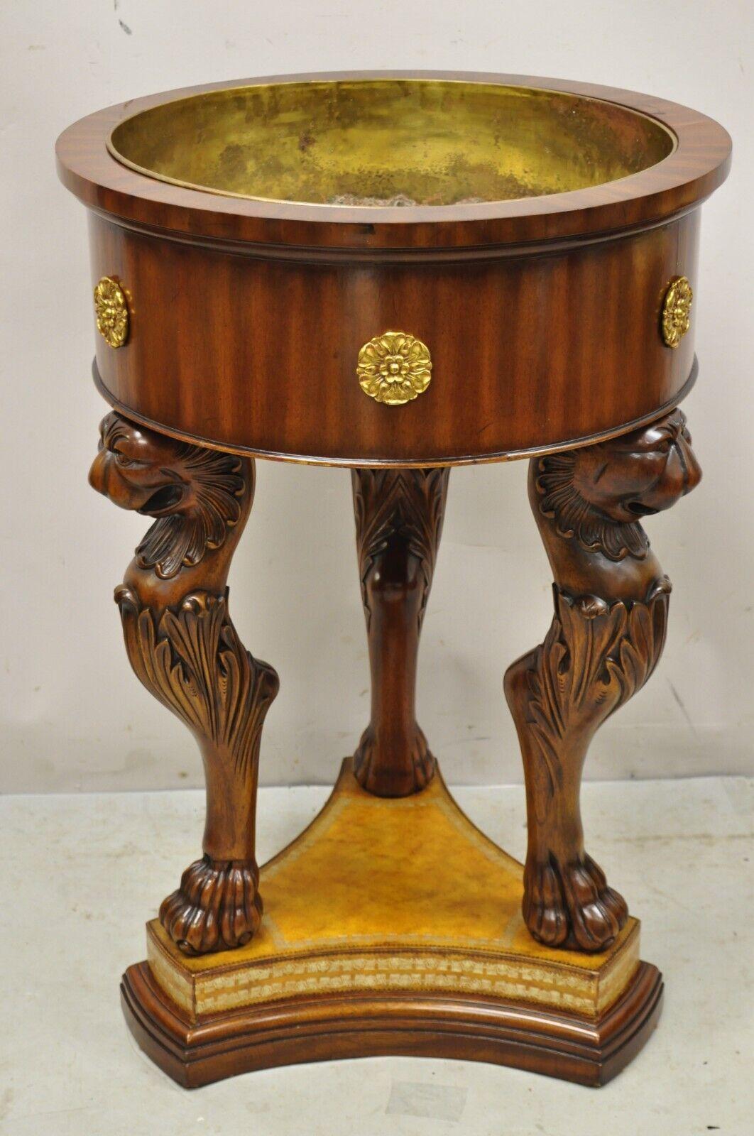 Maitland Smith Regency Style Mahogany Carved Lion Cellaret Planter with Leather Base. Item features a tooled leather base, carved lions and paw feet, brass ormolu, removable brass liner, original label, very nice vintage item, great style and form.