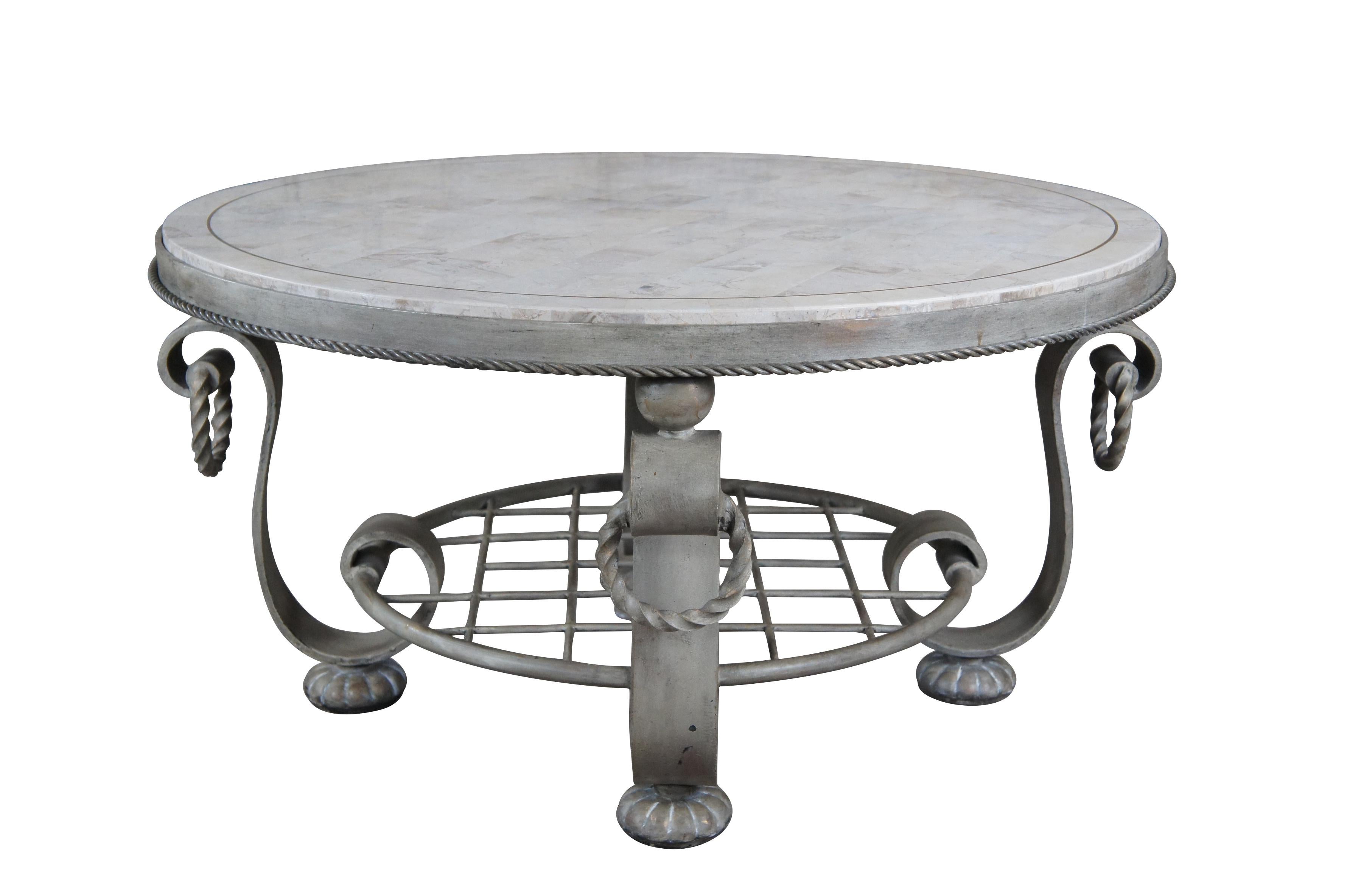 Vintage maitland Smith coffee or cocktail table featuring round form with tessellated stone top supported by heavy tiered iron base with twisted and scrolled accents.

Dimensions:
37