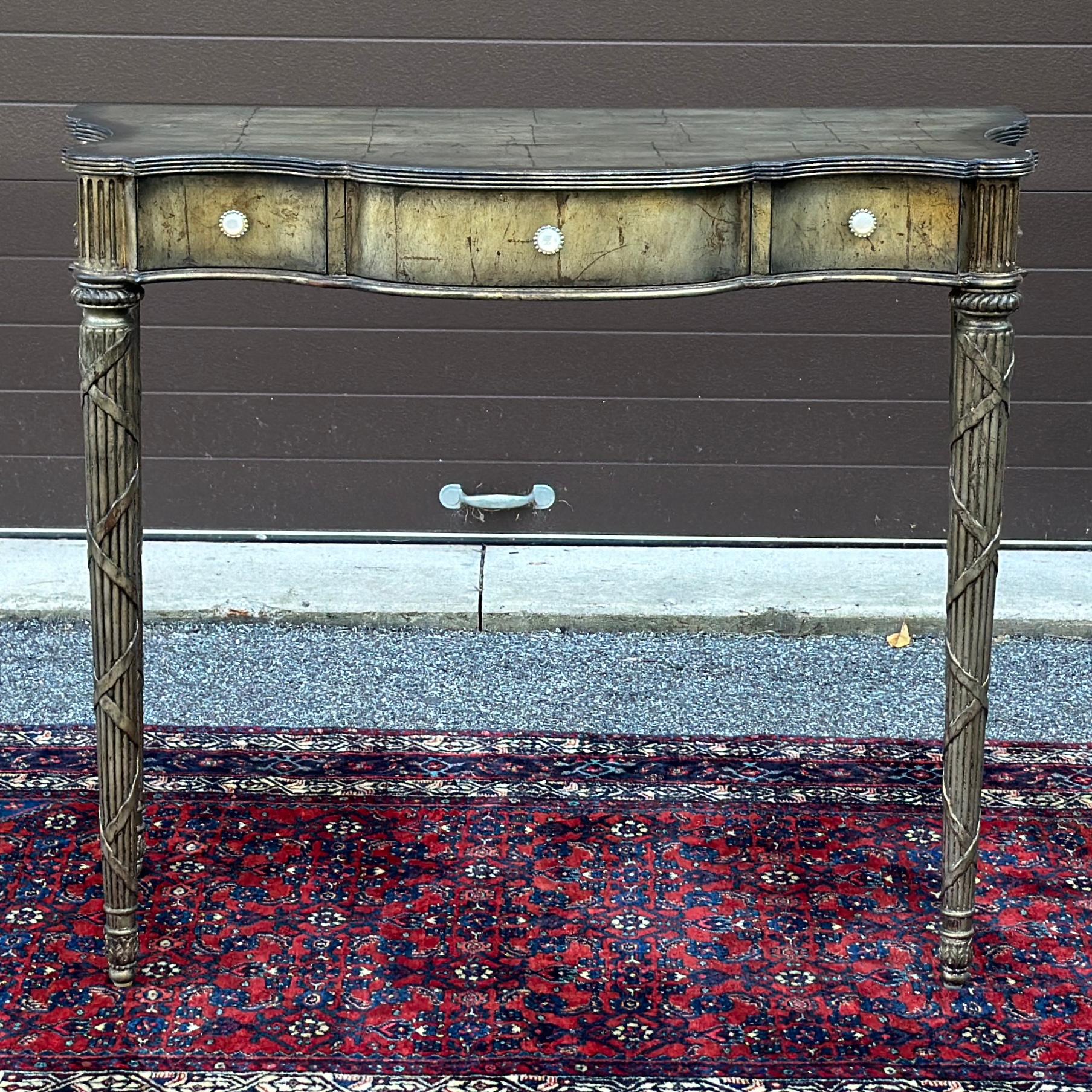 Maitland Smith Silver Leaf Serpentine Console Table With Three Drawers and original distressed silver leaf finish
Signed on back and in drawer. Could also be used as a taller desk.
Knee clearance 29.2 inches 