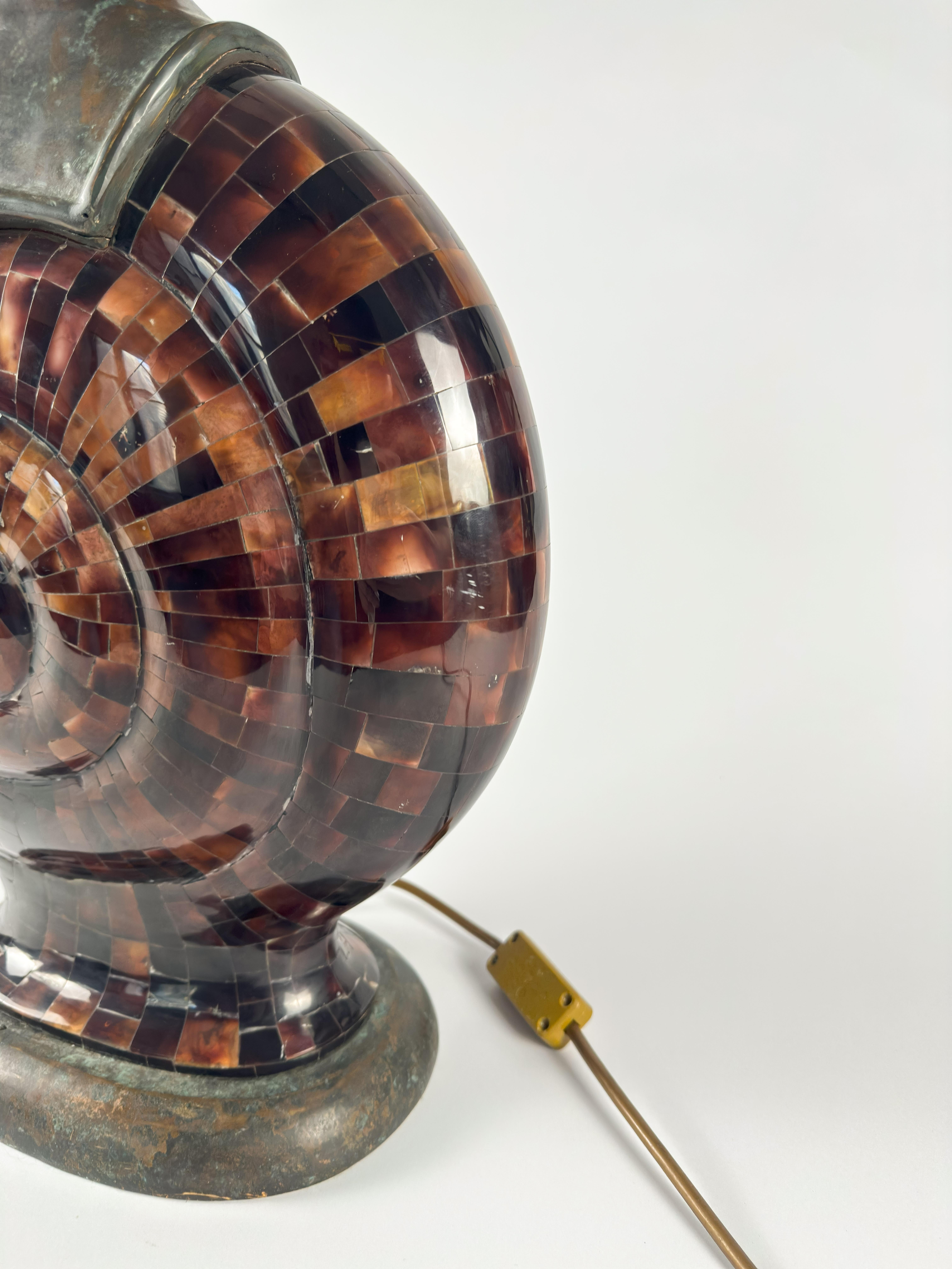 A sculptural and rare statement lamp by Maitland-Smith, crafted in the 1980s and exemplary of the firm’s signature blend of luxury materials and organic form. 

This dramatic design takes the shape of a stylized snail shell, executed in a refined