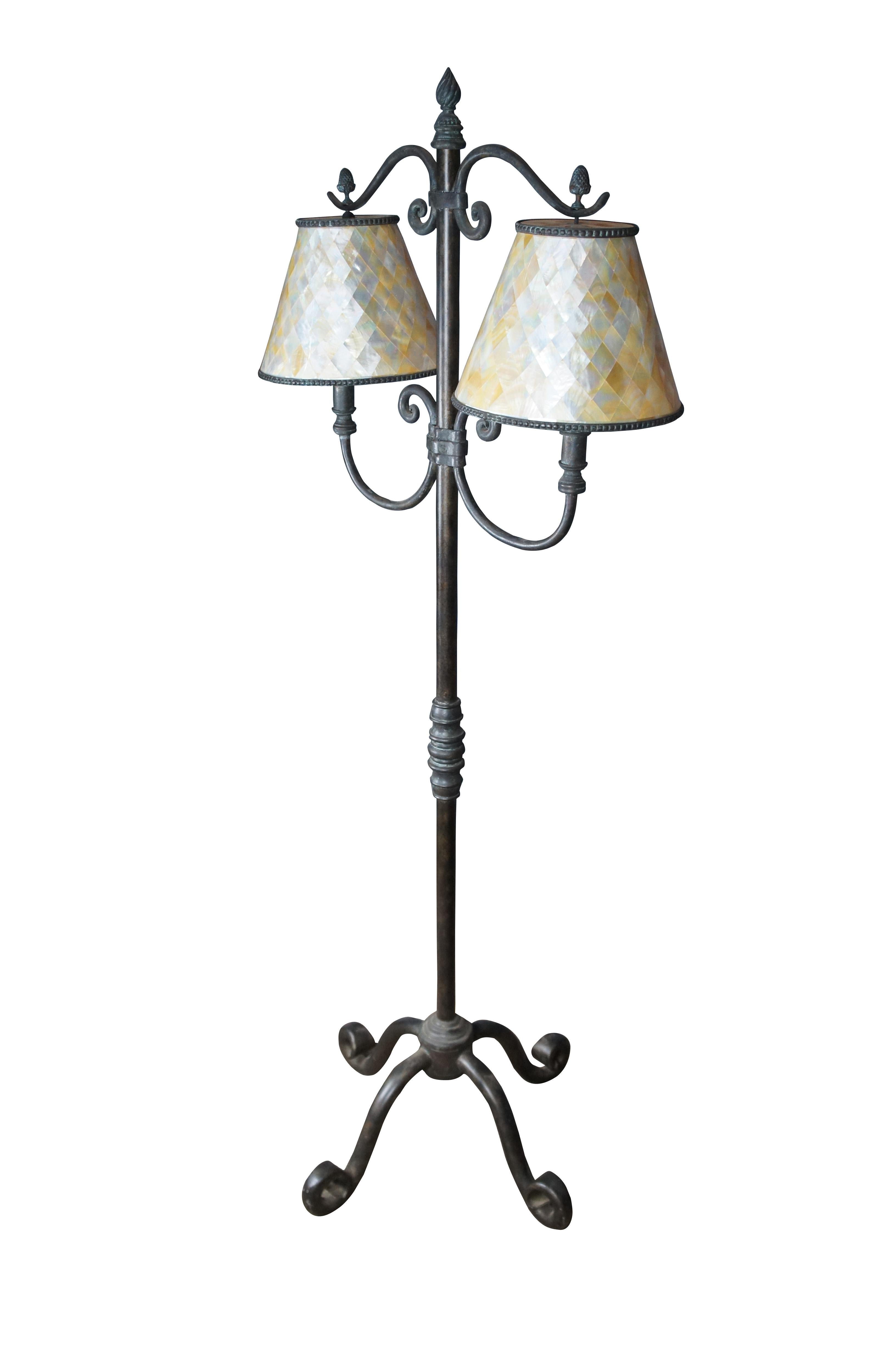 An impressive Iron Floor Lamp Handmade by Maitland Smtih. Features a rich patinated finish with scrolled accents and two Mother of Pearl hanging shades with Tessellated Harlequin pattern. Finial is twisted in a torchiere shape. The lamp is supported