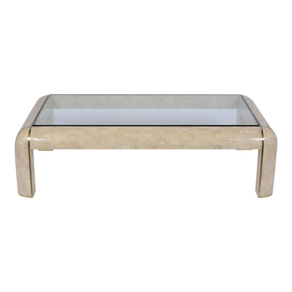 Discover the unique charm of our vintage 1970s Maitland Smith coffee table, meticulously restored to perfection by our expert team of craftsmen. This extraordinary table is crafted from solid wood and elegantly covered with an ivory-colored stone