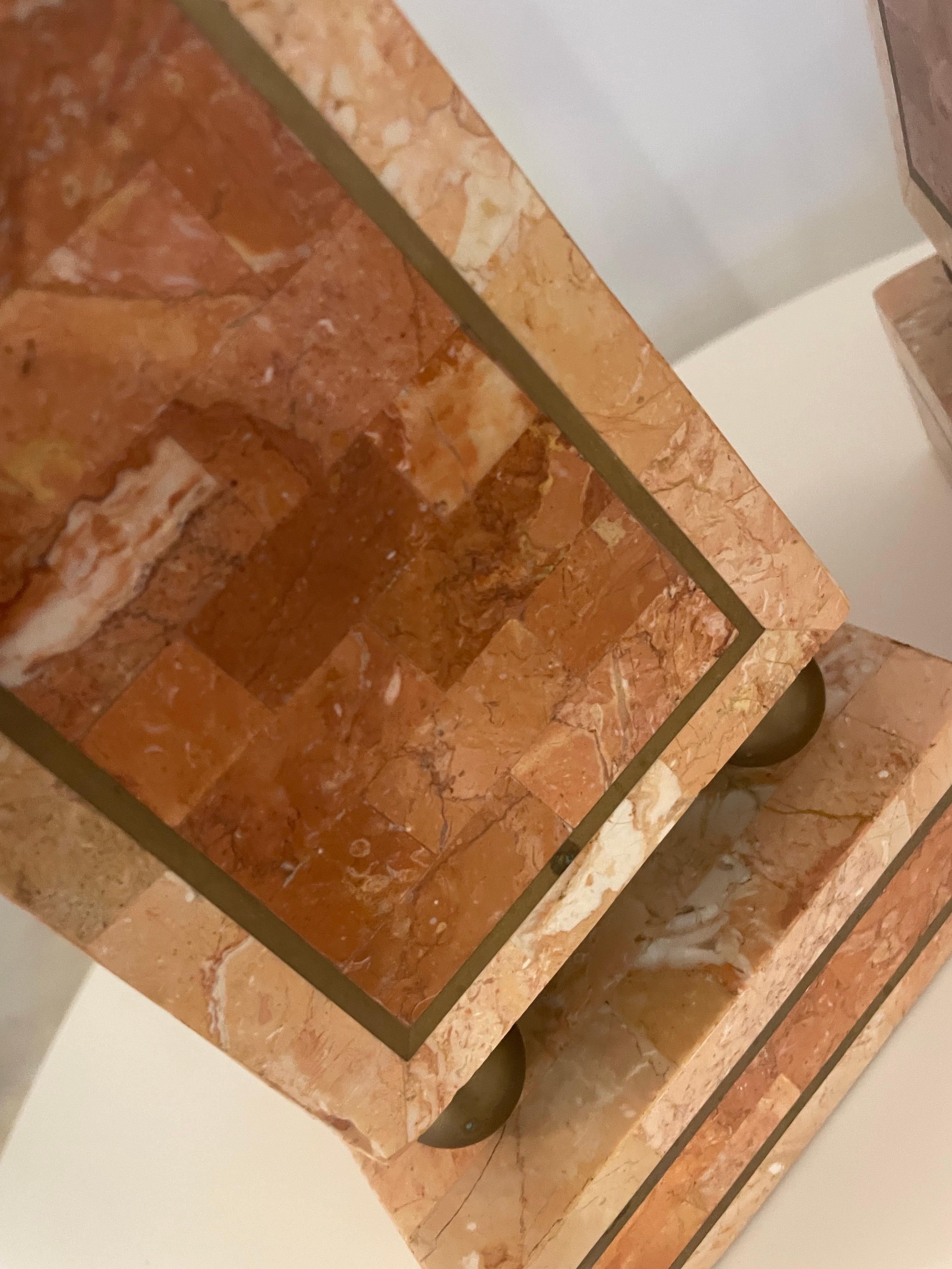 This is a pair of tessellated Terra cotta colored stone and inlaid brass obelisks in great condition 