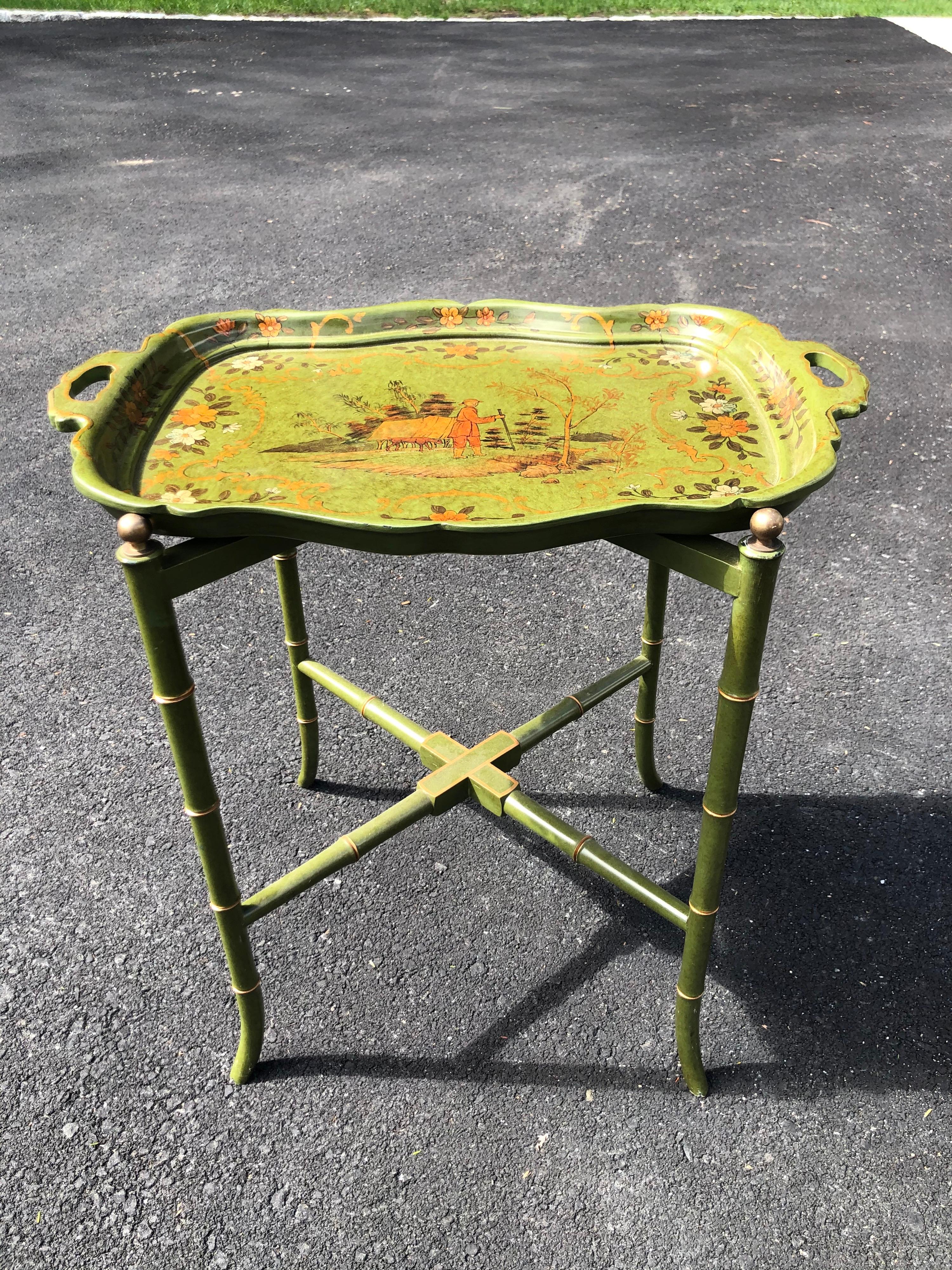 Maitland Smith style Chinoiserie tray table. Olive Green lacquered tray and stand with gold accents and Asian motifs. This item can easily parcel ship for under $100. Please provide a zip code for exact quote.