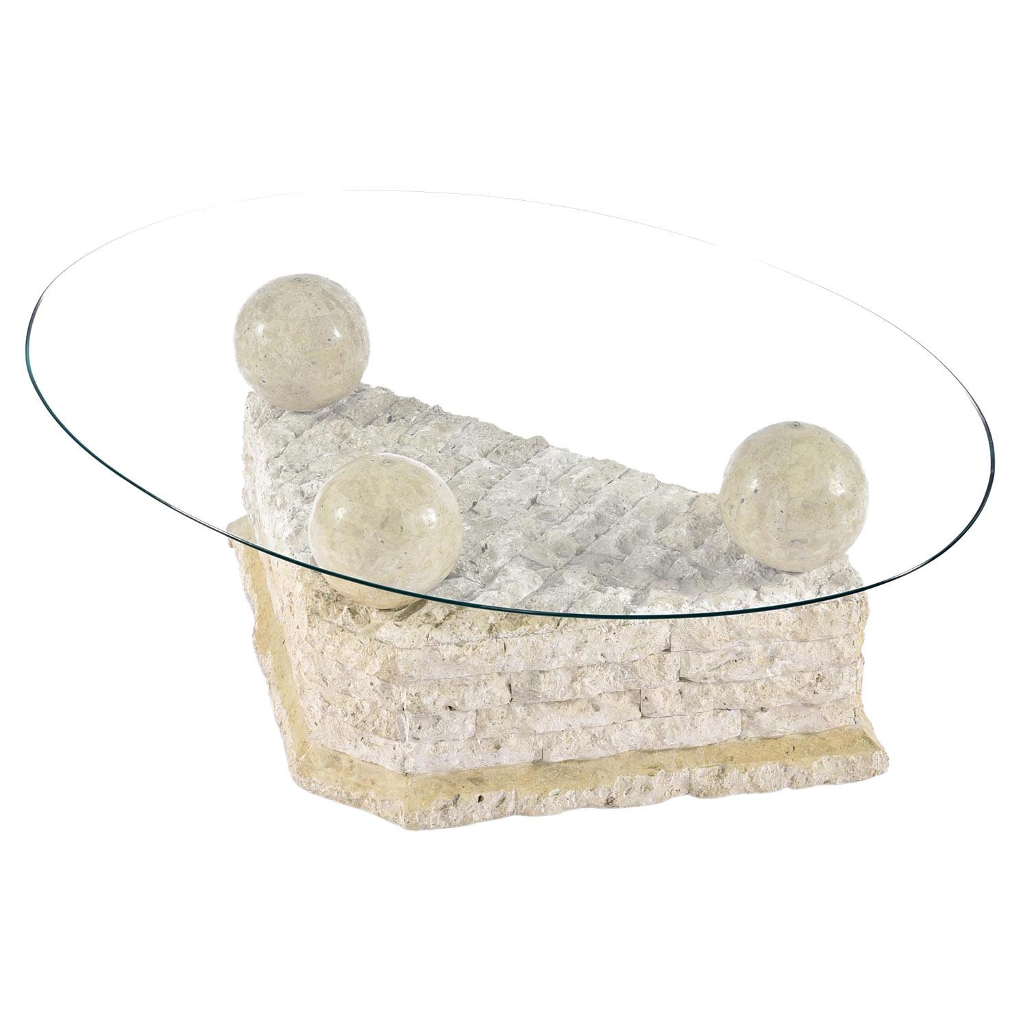 Captivating Mactan stone pedestal coffee table. Designed in the style of Maitland-Smith. Mactan Stone is a kind of white coral quarried in Philippines. The massive, smooth, tessellated stone orbs that sit atop the coral feature exotically marbled