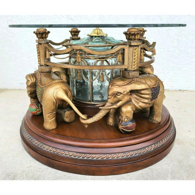 Offering one of our recent palm beach estate fine furniture acquisitions of a
wonderful fun rotating elephants carousel glass top coffee cocktail table

It comes with a 30