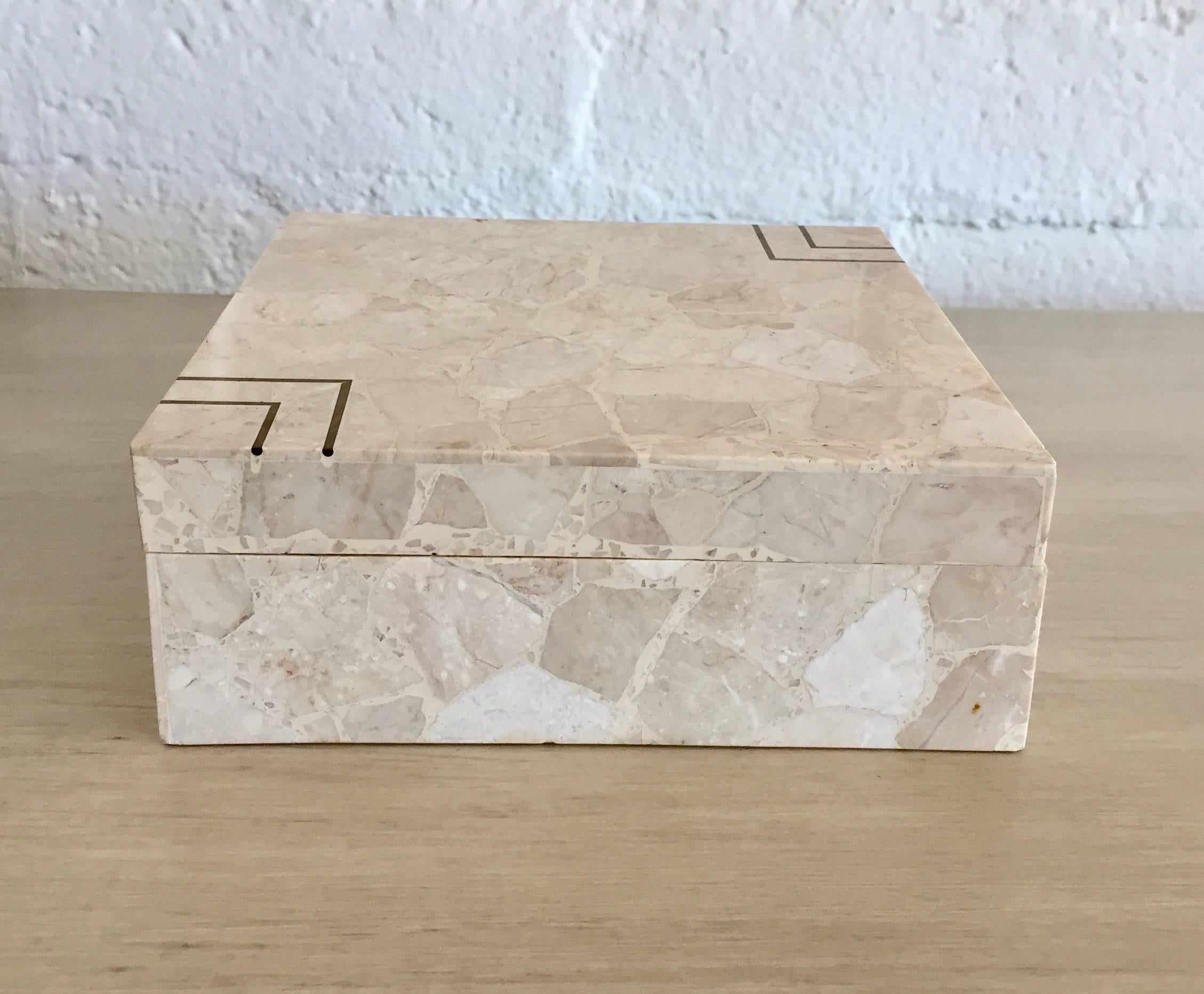 A handsome square stone box made of terrazzo and inlaid brass. The terrazzo has beautiful light and greyish pieces of marble stone throughout. The box is lined with cream felt and is also felted at the bottom.