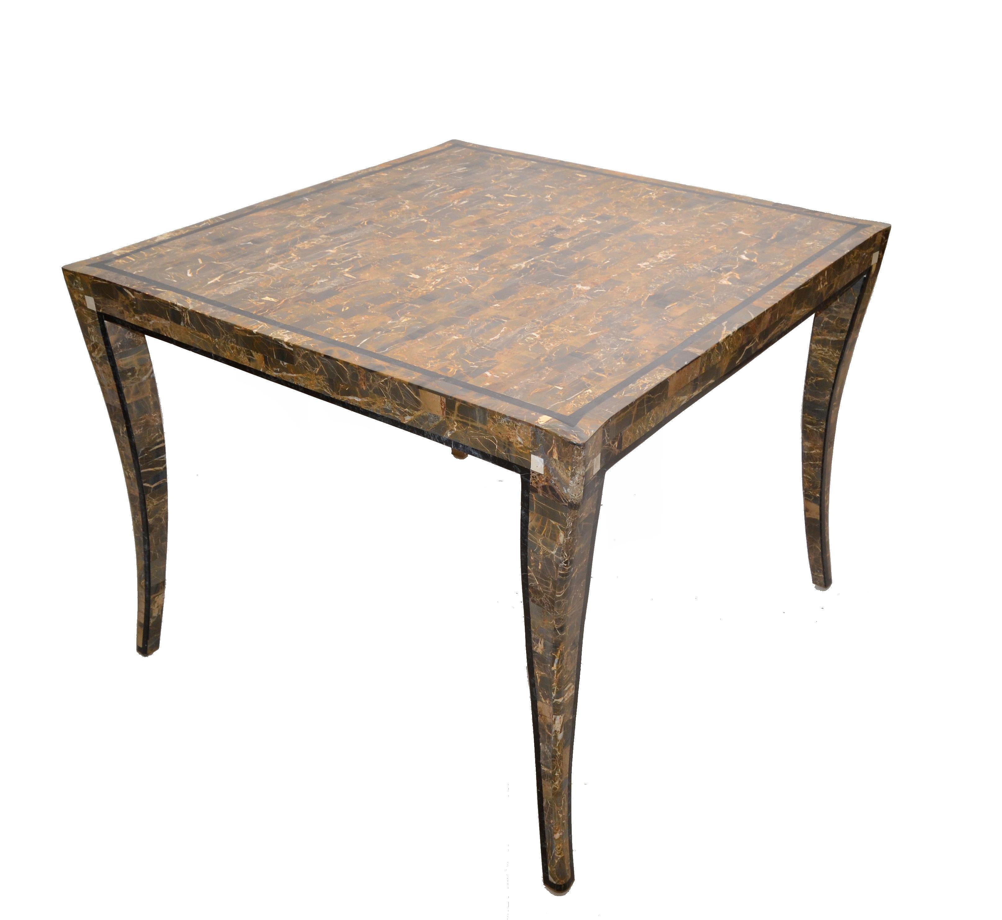 Neoclassical square game table, card & tea table attributed to Maitland Smith.
A gray and cinnamon brown tessellated stone over wood covered table or center table with curved legs.
The Gatherings round this Table brings a lot of fun into Your Home.