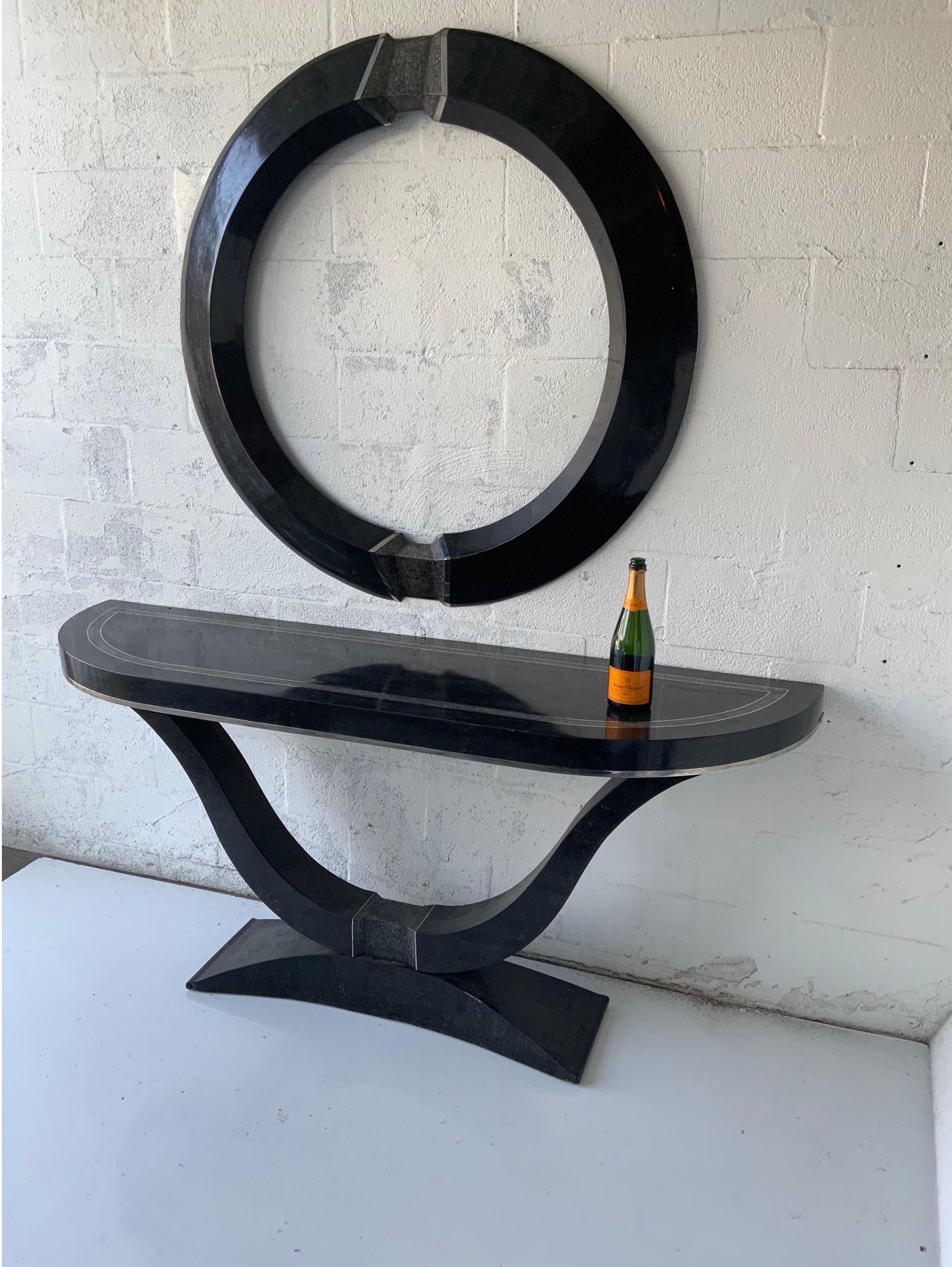 An Art Deco style mirror and console in tessellated stone, executed in the manner of Maitland Smith. Mixed media, consisting of tessellated stone, crushed stone, and chrome. With matching mirror. Art Deco style, with predominantly black color. Made