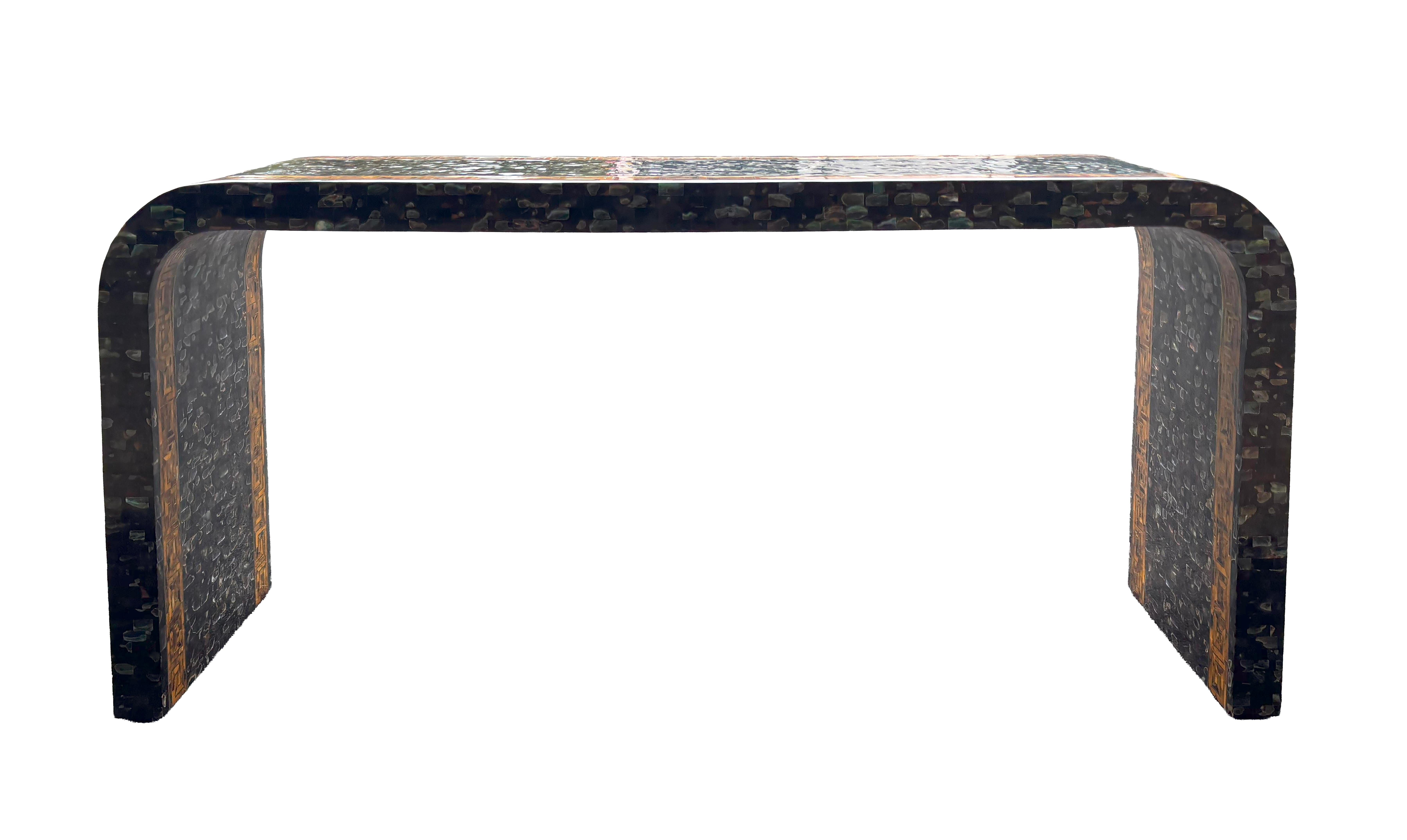 Rectangular with overall faux mother of pearl with a border of faux tortoise with brass inlays.