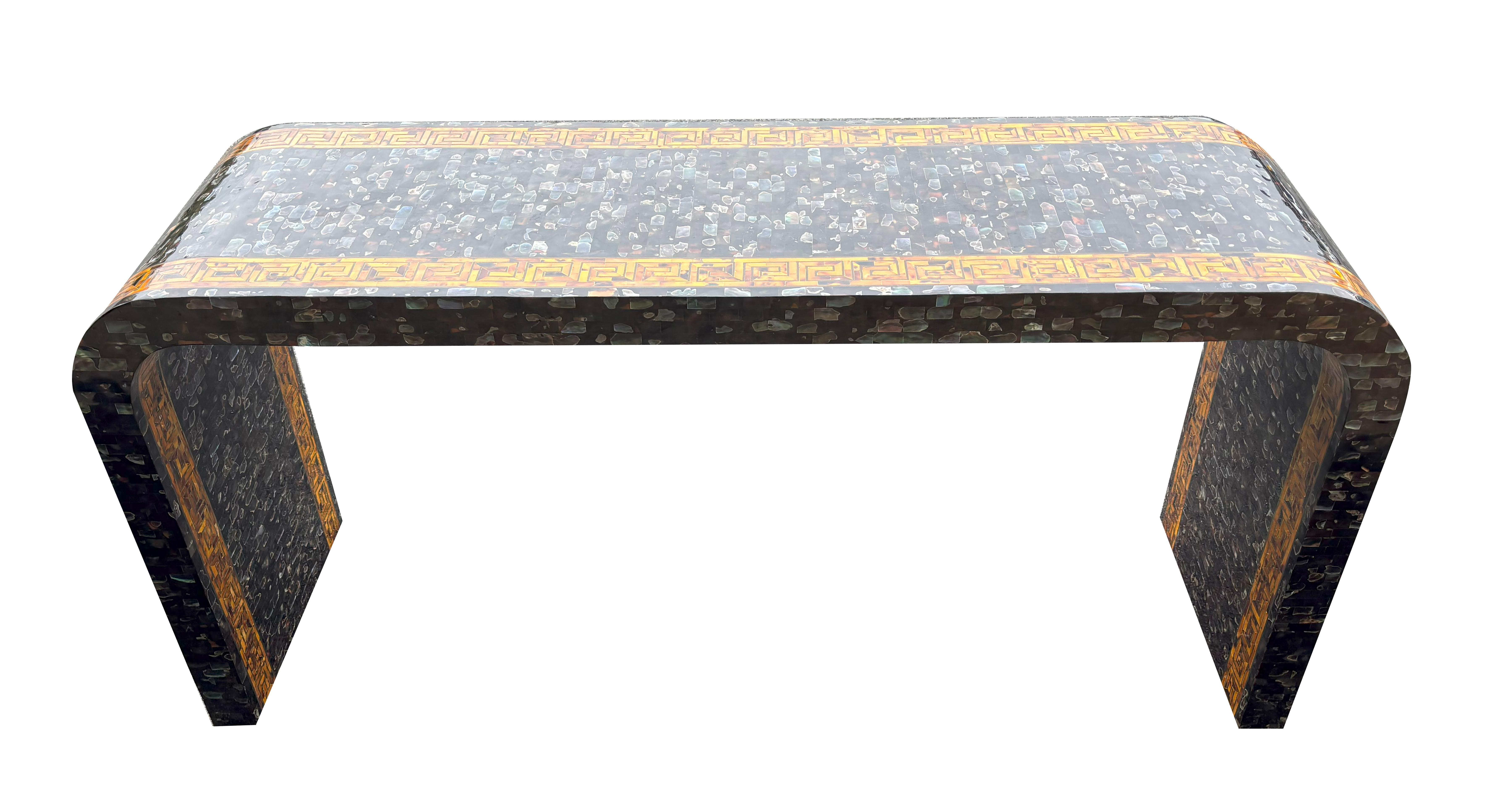 Rectangular with overall faux mother of pearl with a border of faux tortoise with brass inlays.