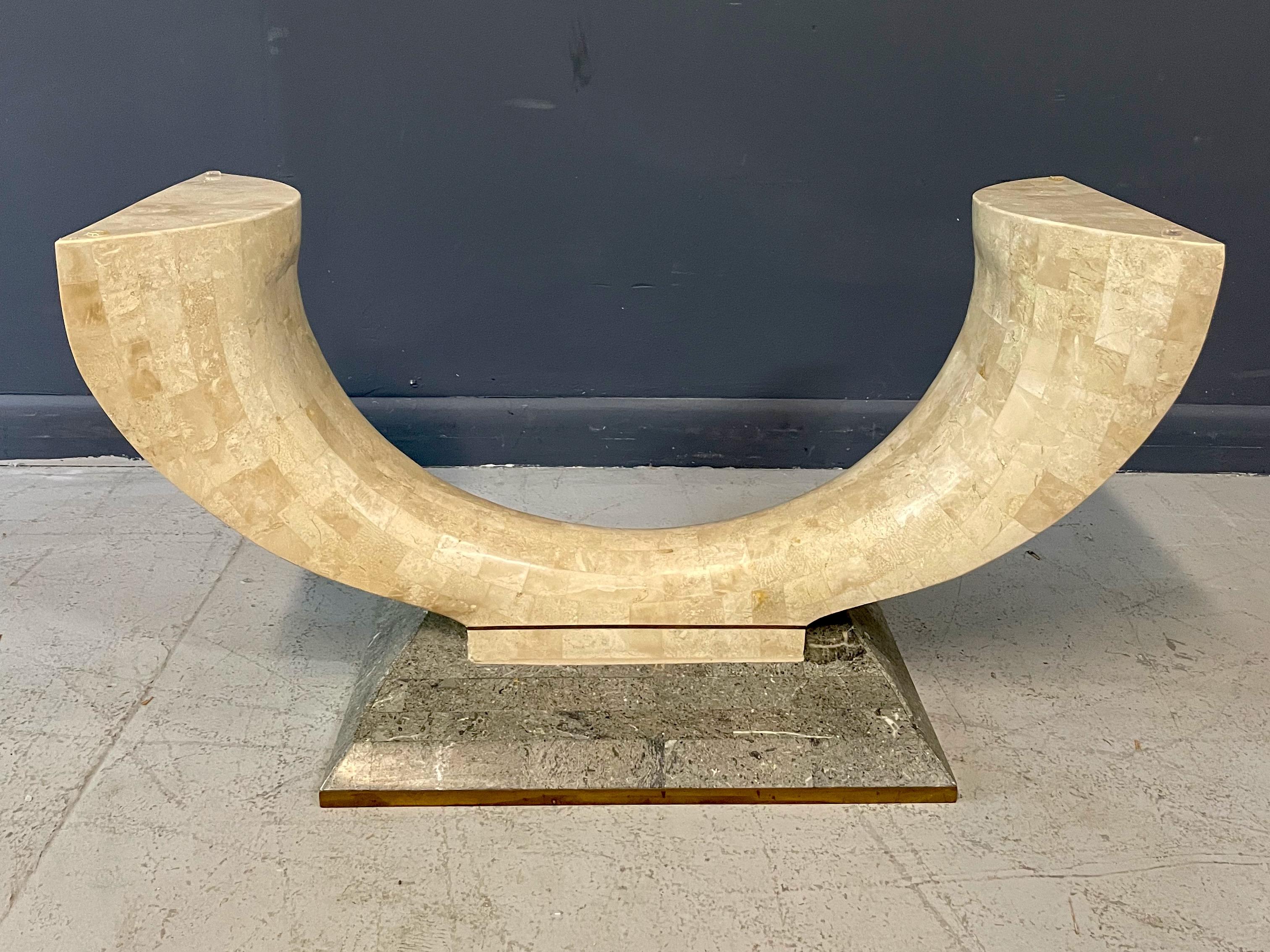 This wonderful coffee table is striking in its unusual shape and will make a statement in your home! Tessellated fossil stone and brass detailing make this a very special table.